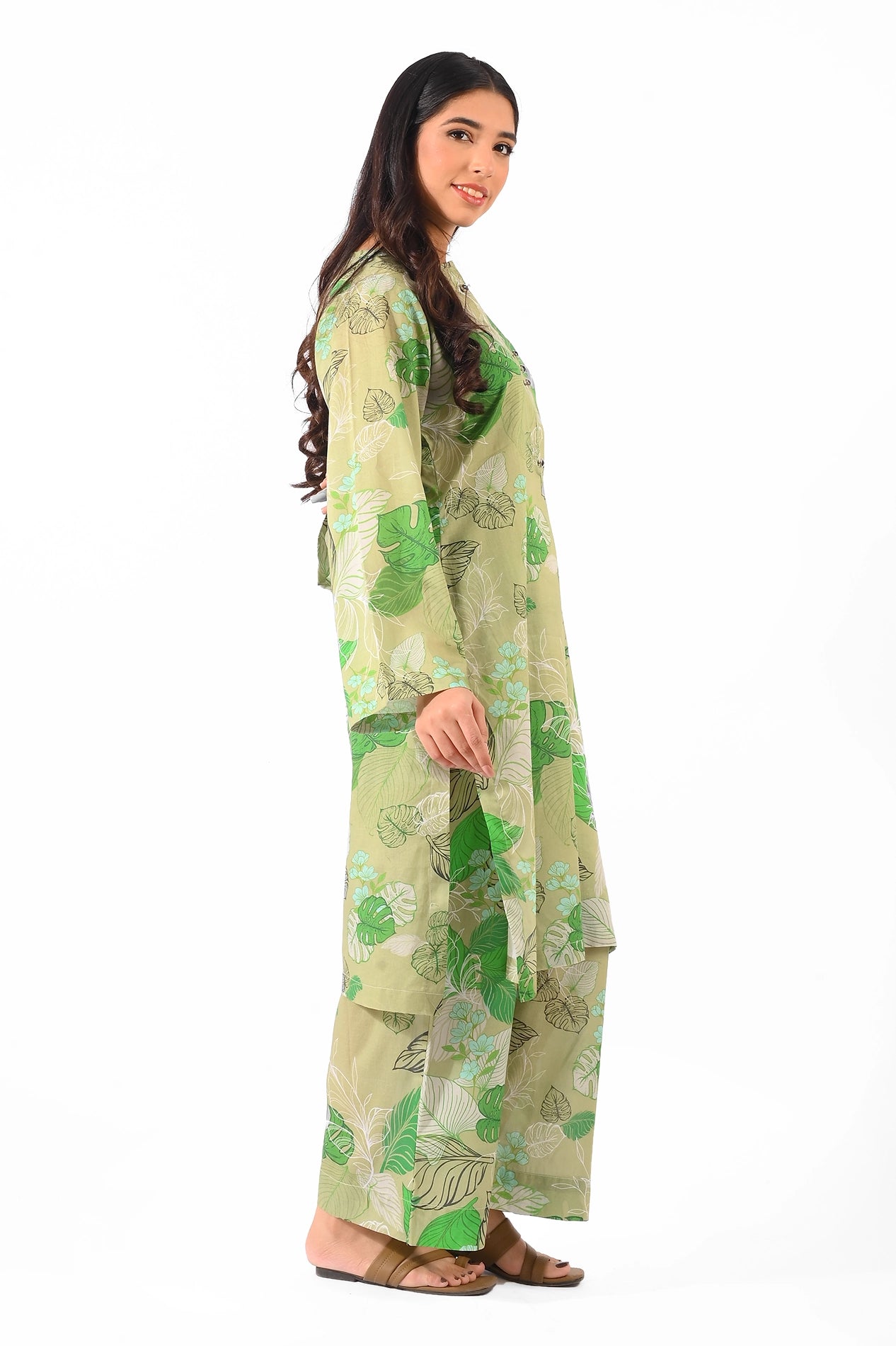 Side profile showcasing the flowing design of the kurta and matching trousers with green botanical motifs BOLDSTEP BOLDSTEP.PK