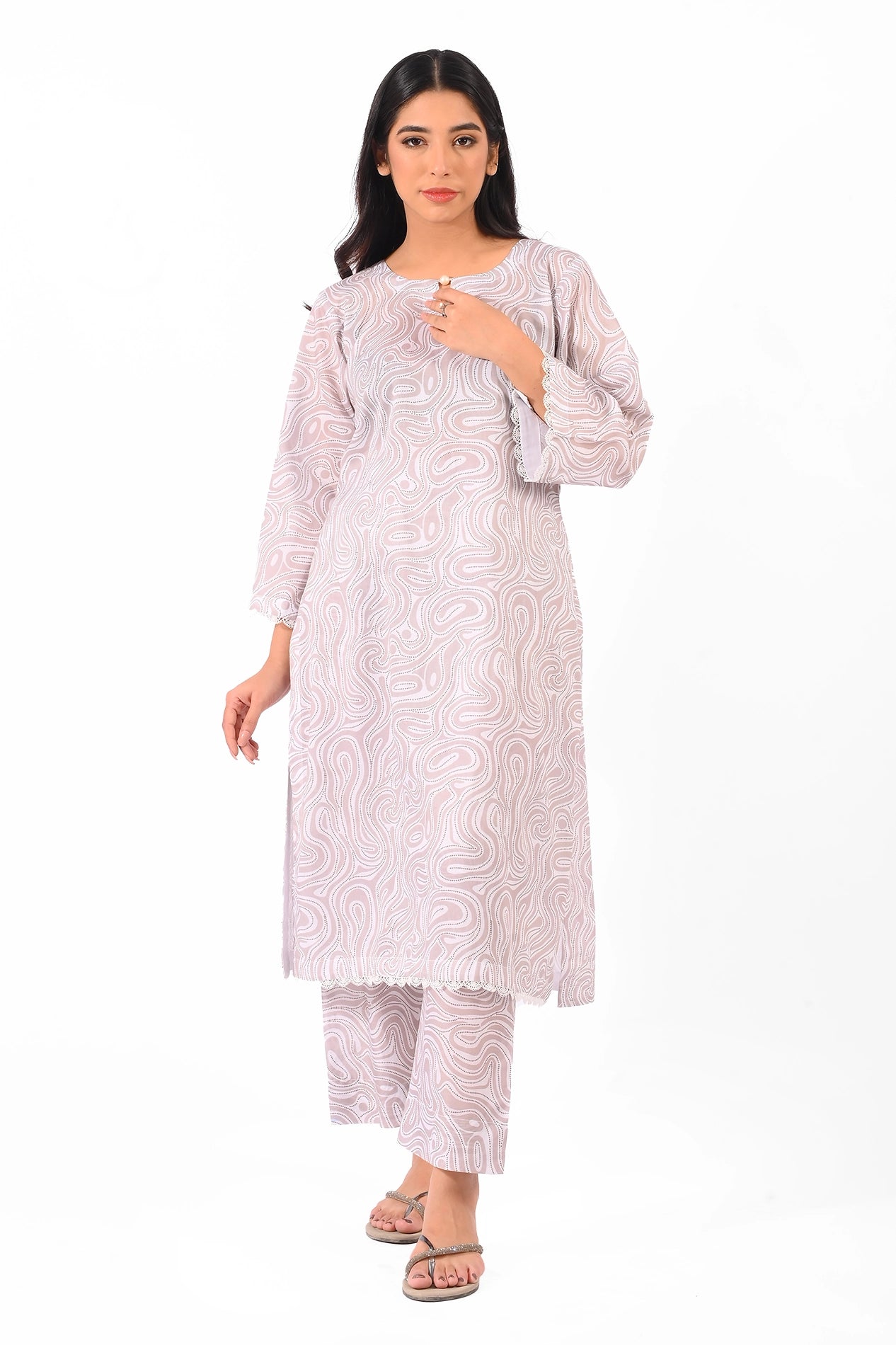 A model showcasing a soft pastel printed two-piece dress with an elegant swirl pattern and intricate detailing. BOLDSTEP BOLDSTEP.PK