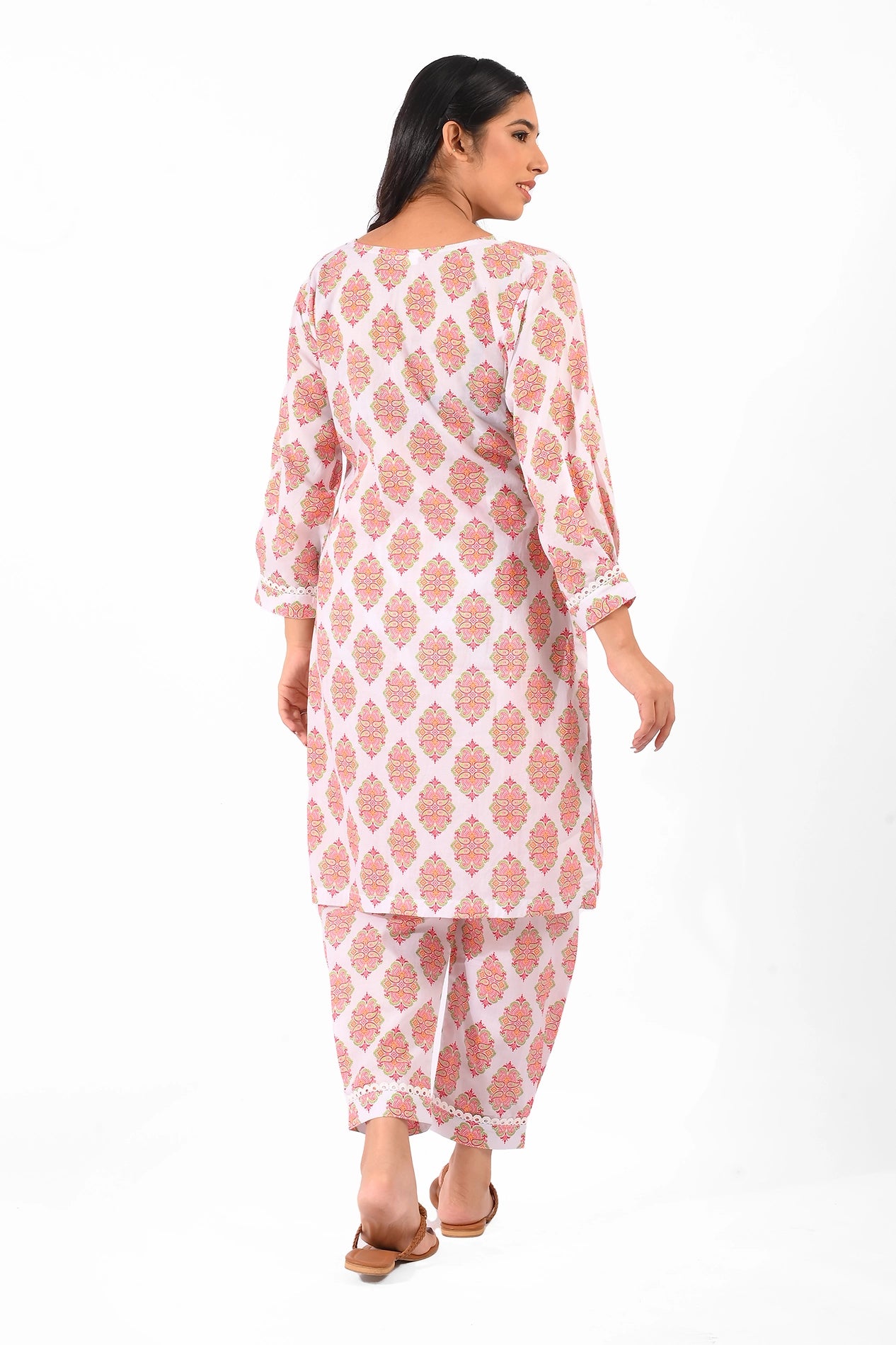 Back view of a vibrant orange Pakistani lawn dress with geometric patterns. The model showcases the long kurta paired with matching pants, perfect for stylish summer wear. BOLDSTEP BOLDSTEP.PK