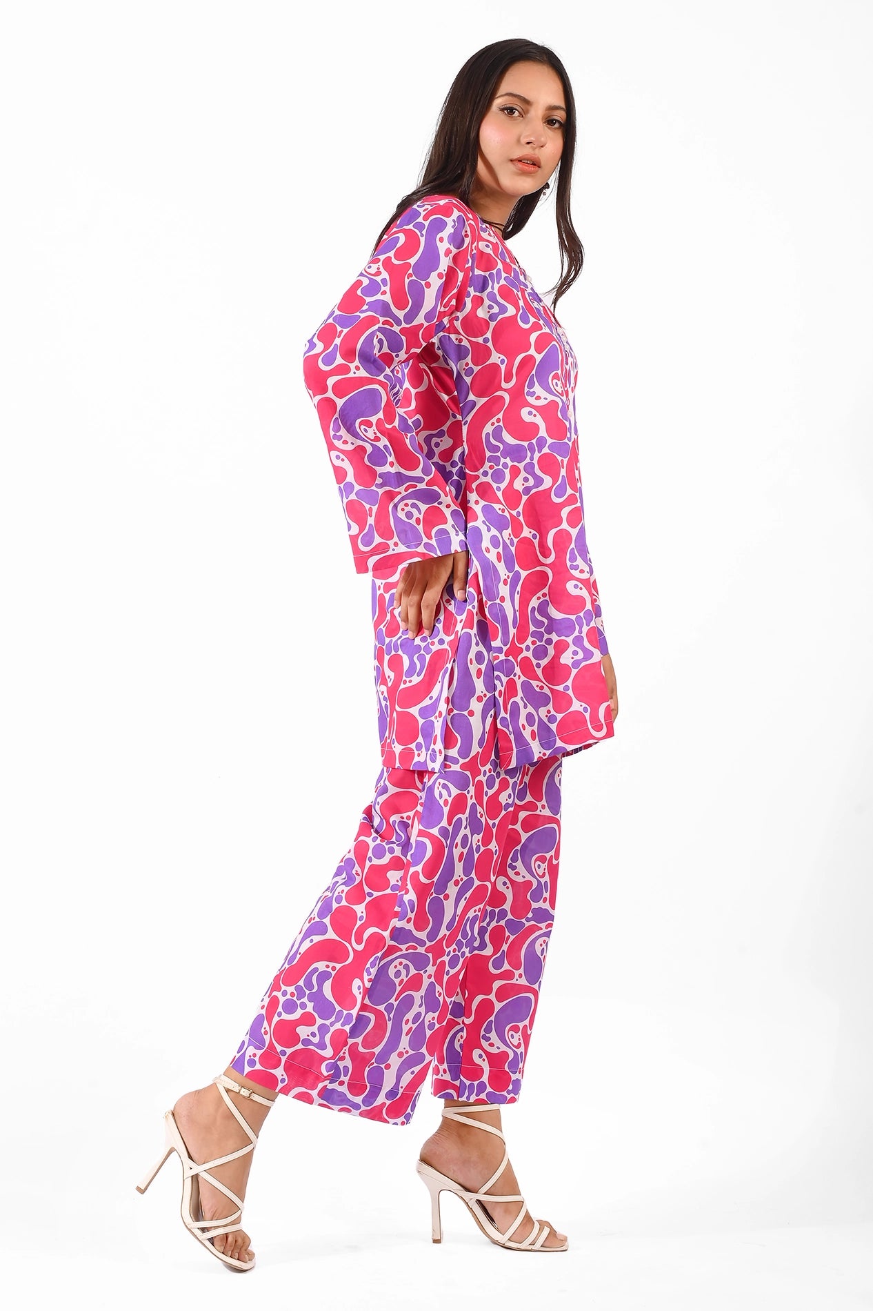 Full-body view of a model wearing a vibrant printed kurta and pants in shades of pink and purple BOLDSTEP BOLDSTEP.PK