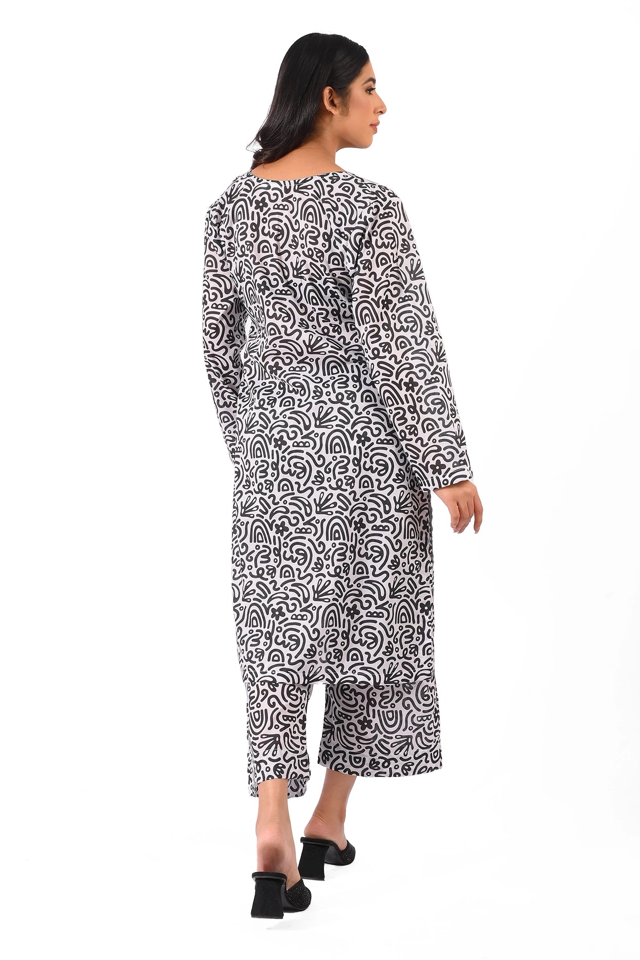 Back view of a black and white printed dress, revealing a gracefully flowing design with a cohesive pattern extending to the trousers. BOLDSTEP BOLDSTEP.PK