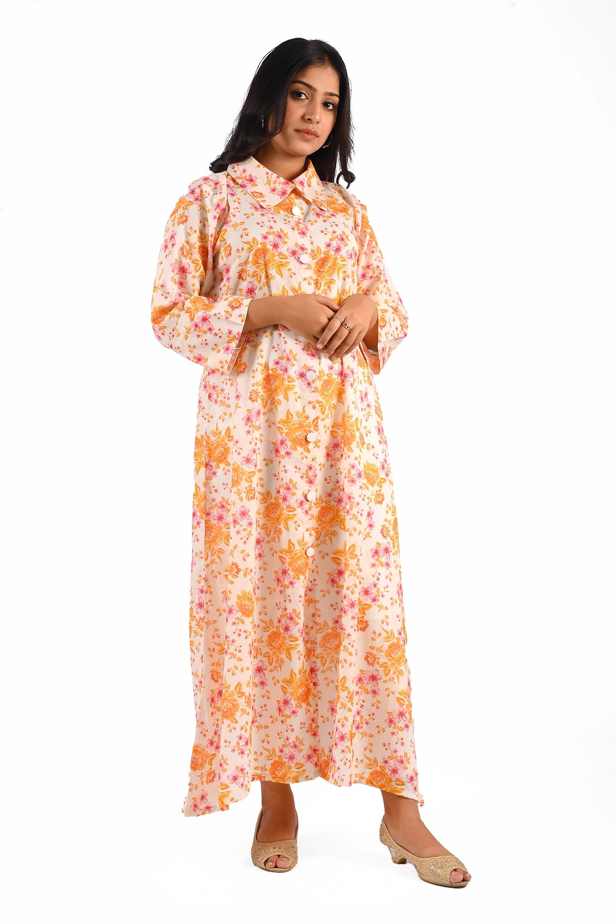 Full front view of a floral printed long dress with orange and pink patterns, worn by a model standing confidently. BOLDSTEP BOLDSTEP.PK