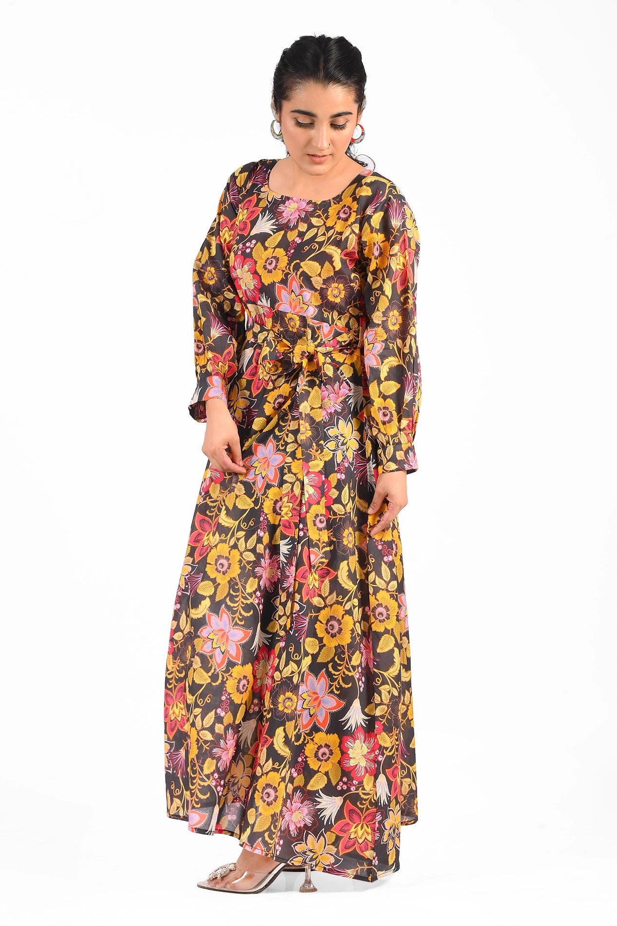 Side view of the floral black maxi dress showcasing its detailed flower pattern and tied waistbelt, enhancing its flattering fit and flow. BOLDSTEP BOLDSTEP.PK