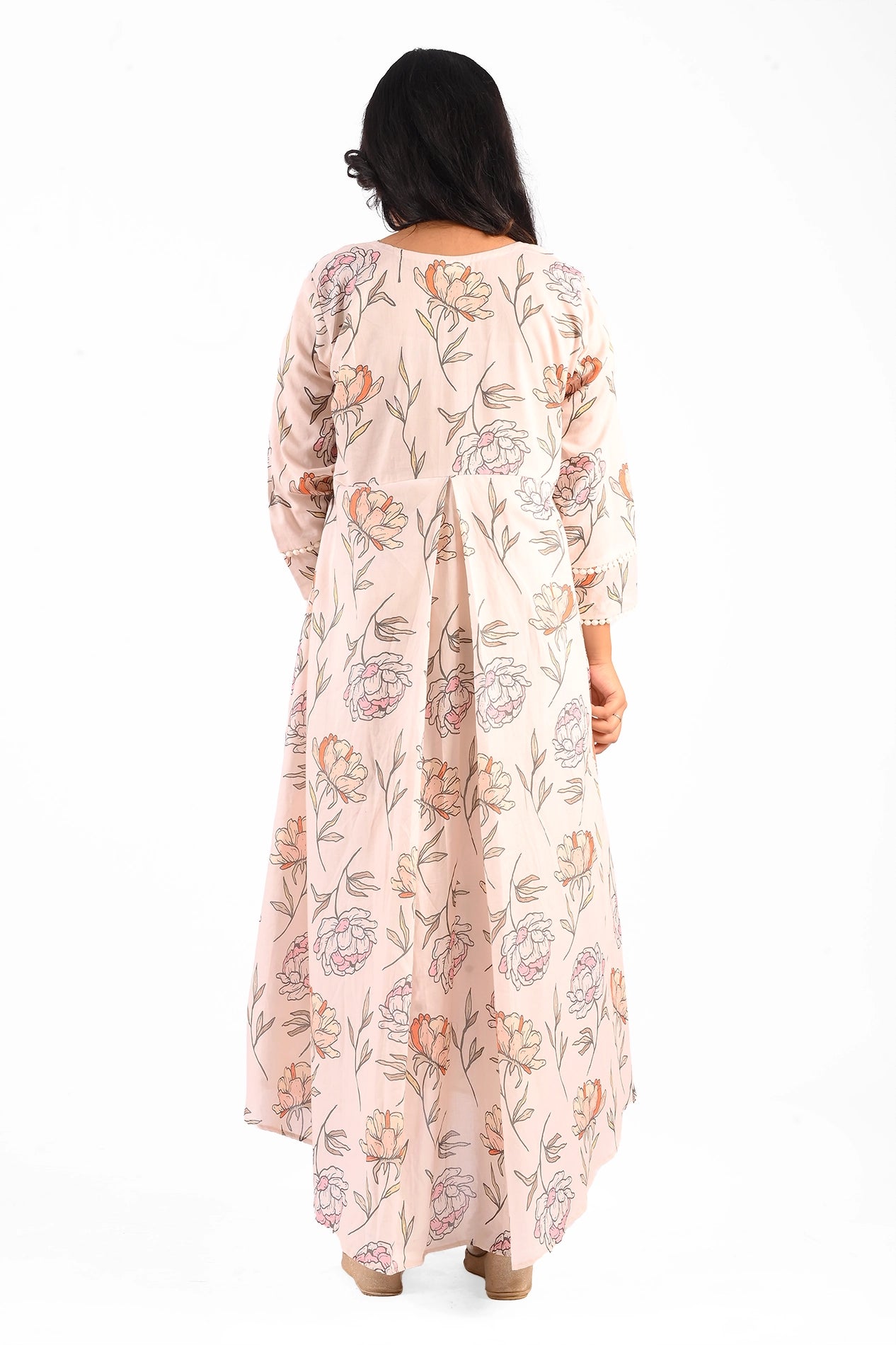 Back view of a pastel pink floral dress showcasing its flowing hemline and beautifully printed floral pattern. The back design retains the simplicity and elegance of the outfit. BOLDSTEP boldstep.pk