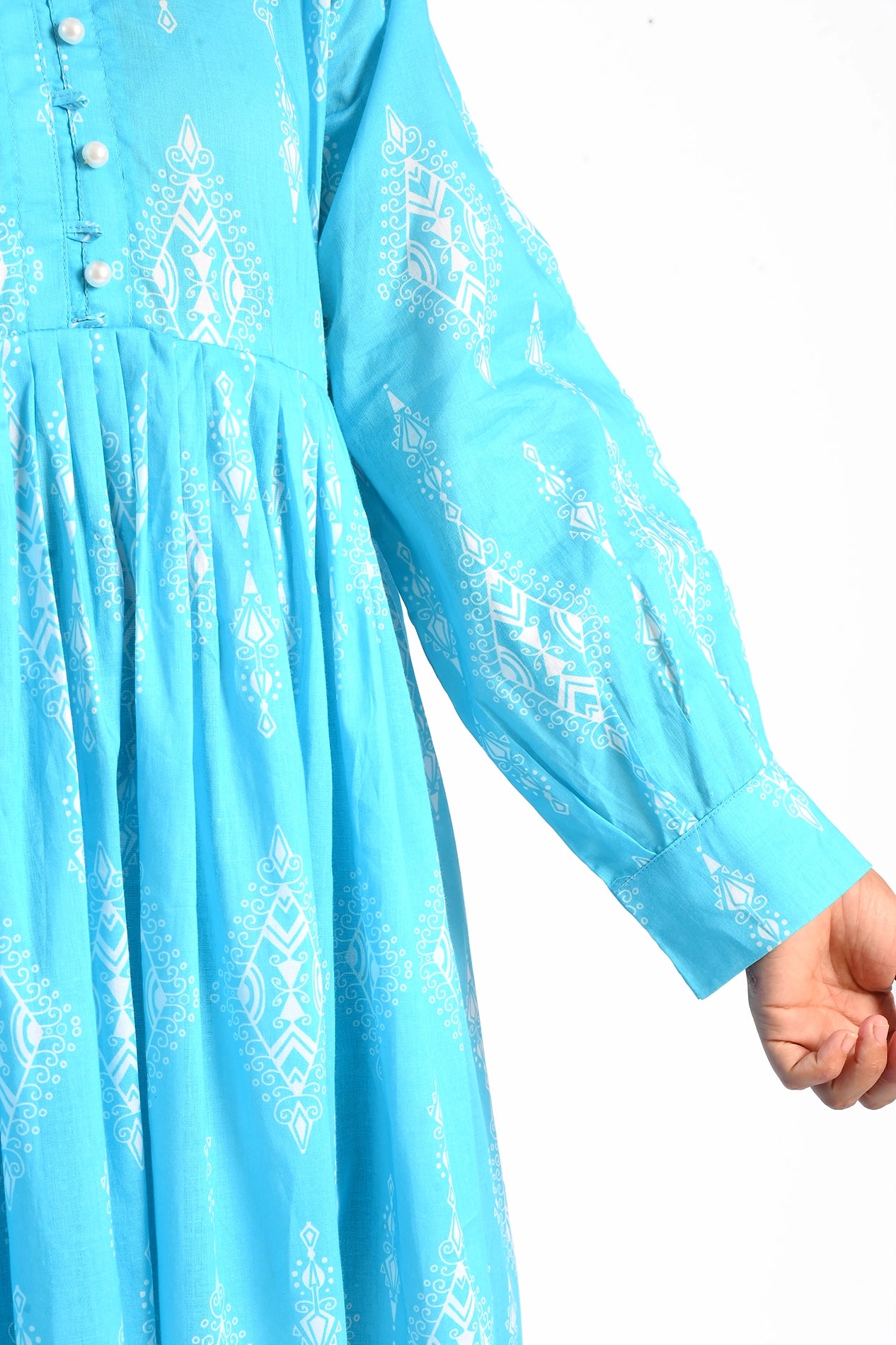 A close-up of the sleeve of the blue maxi dress, displaying the cuff detail and the intricate white geometric print. boldstep boldstep.pk