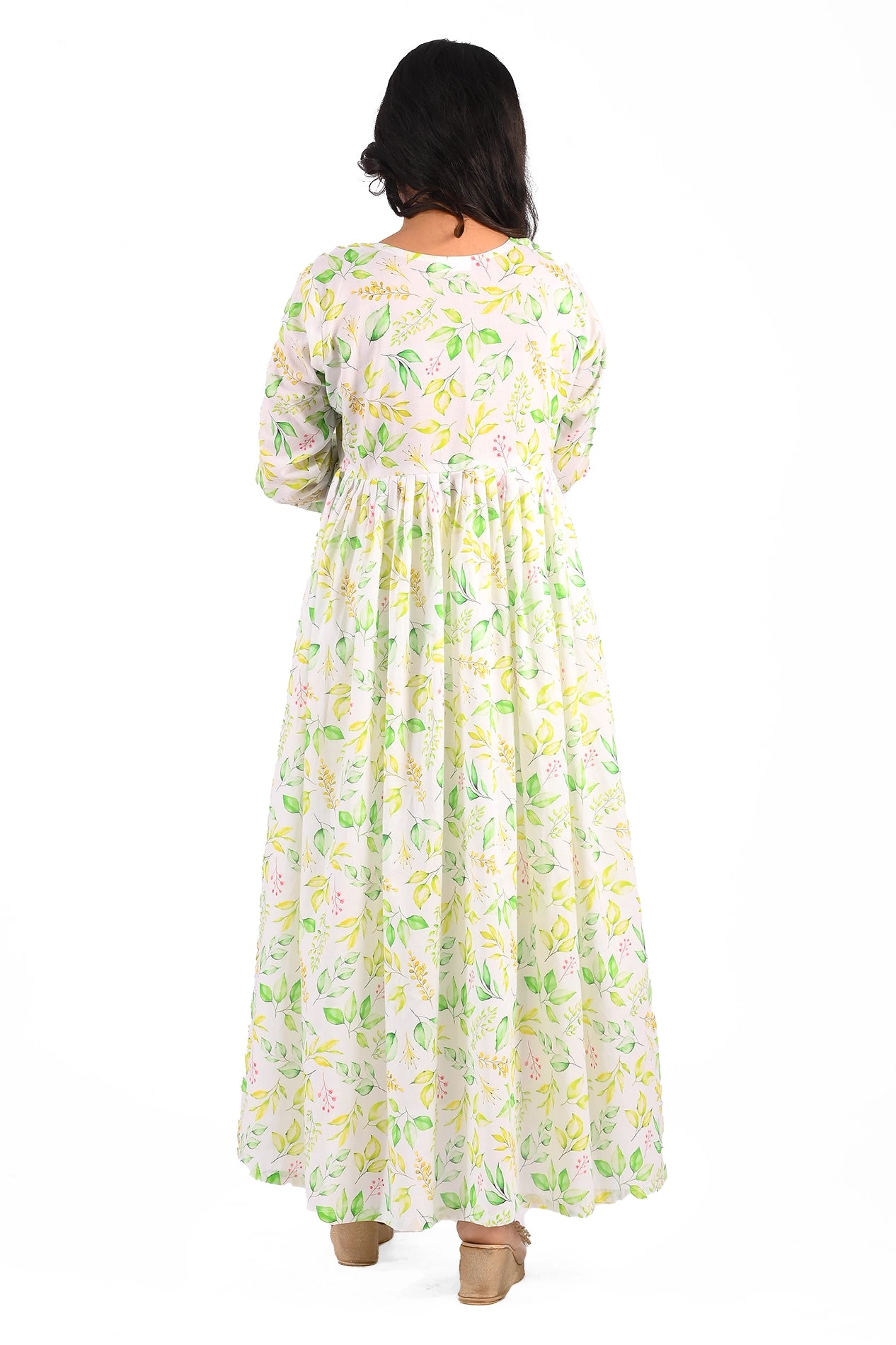 The back of the dress reveals its simplicity, with the green and yellow leafy print continuing throughout. The fit flares out gently from the waist for a modest yet graceful look. BOLDSTEP BOLDSTEP.PK