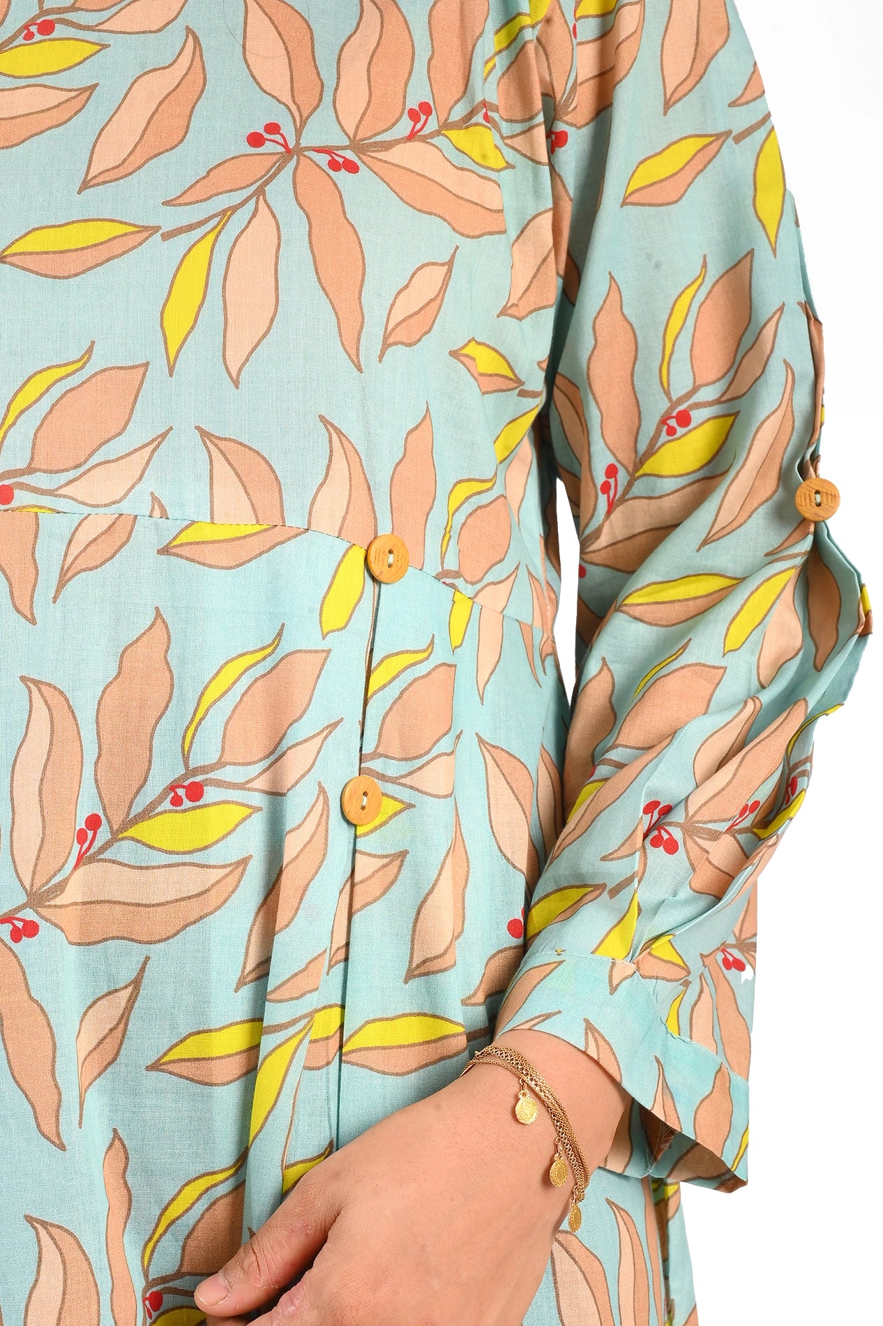 A detailed close-up of the sleeve and bodice area, showcasing the wooden buttons, the elegant print design, and the gold bracelet complementing the outfit. BOLDSTEP BOLDSTEP.PK