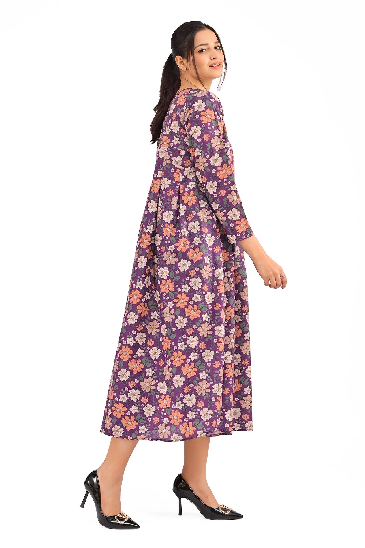 Side view of a purple floral maxi dress with pleated design, showcasing its flowy silhouette and comfortable fit. BOLDSTEP BOLDSTEP.PK