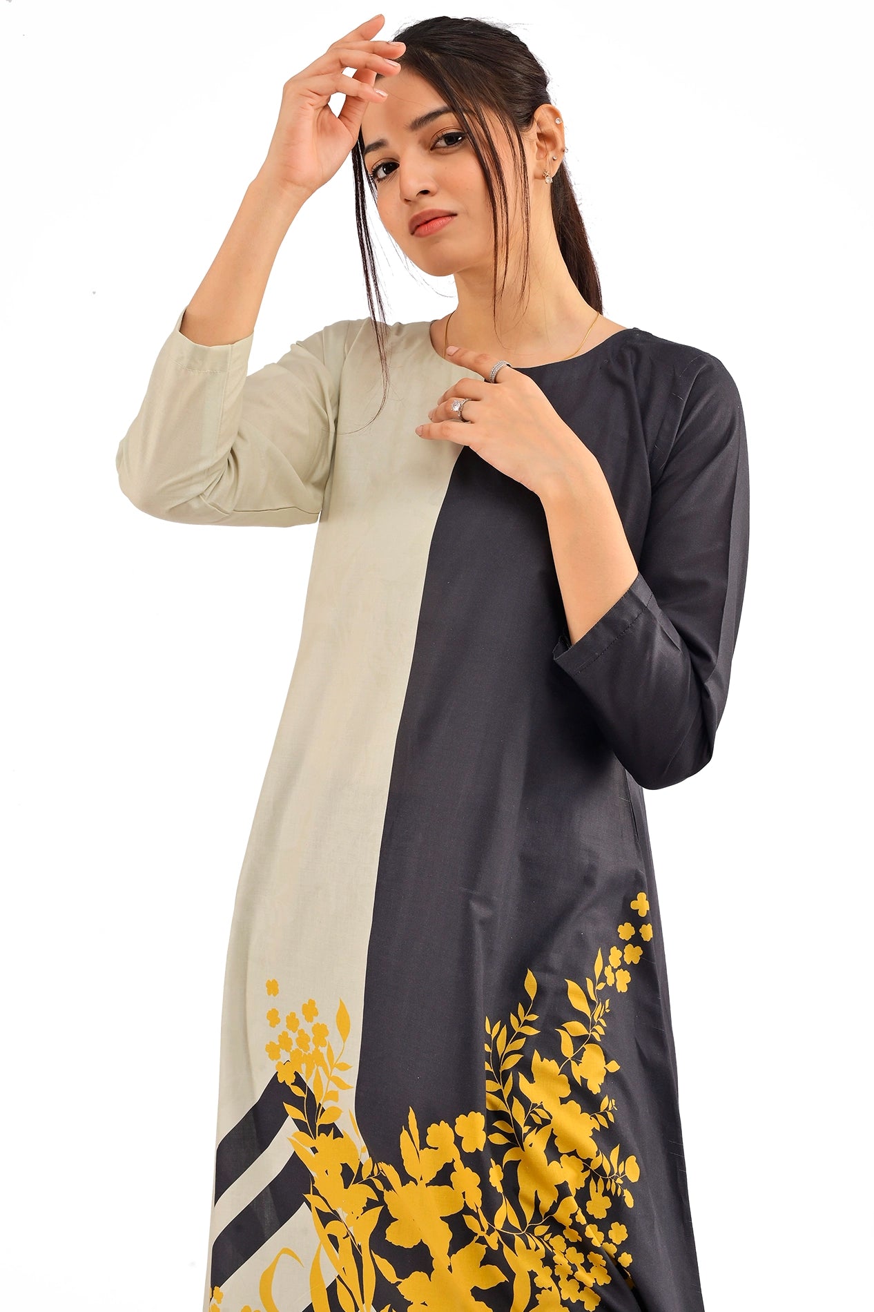 A close-up of the dress's upper portion, focusing on the beige and black panel contrast and the delicate yellow floral pattern along the bottom. BOLDSTEP BOLDSTEP.PK