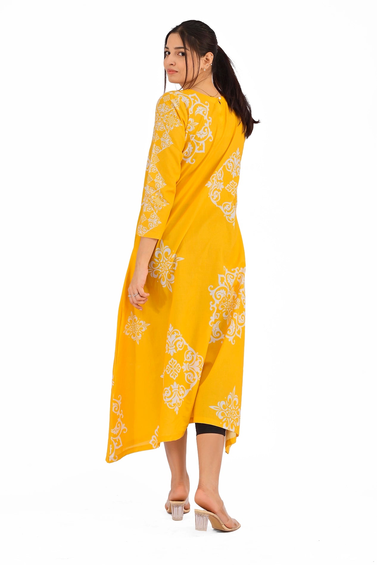 Back view of the yellow long dress featuring intricate white block patterns across the fabric. The dress flows gently, highlighting its relaxed yet sophisticated style.BOLDSTEP BOLDSTEP.PK