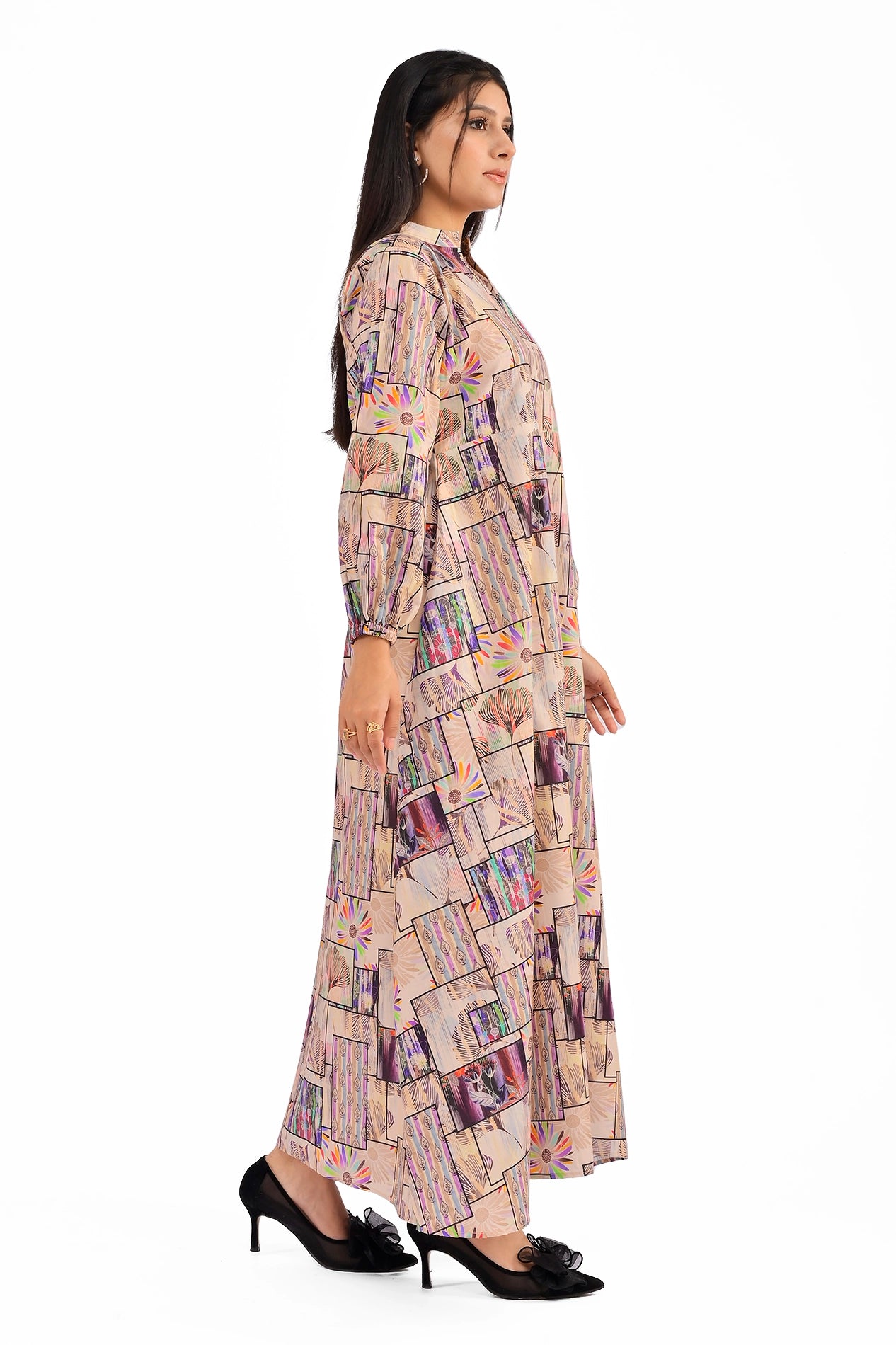 Side profile of a beige patchwork dress with a vibrant mix of floral and abstract patterns, showcasing its flowing A-line silhouette and stylish design details. BOLDSTEP BOLDSTEP.PK