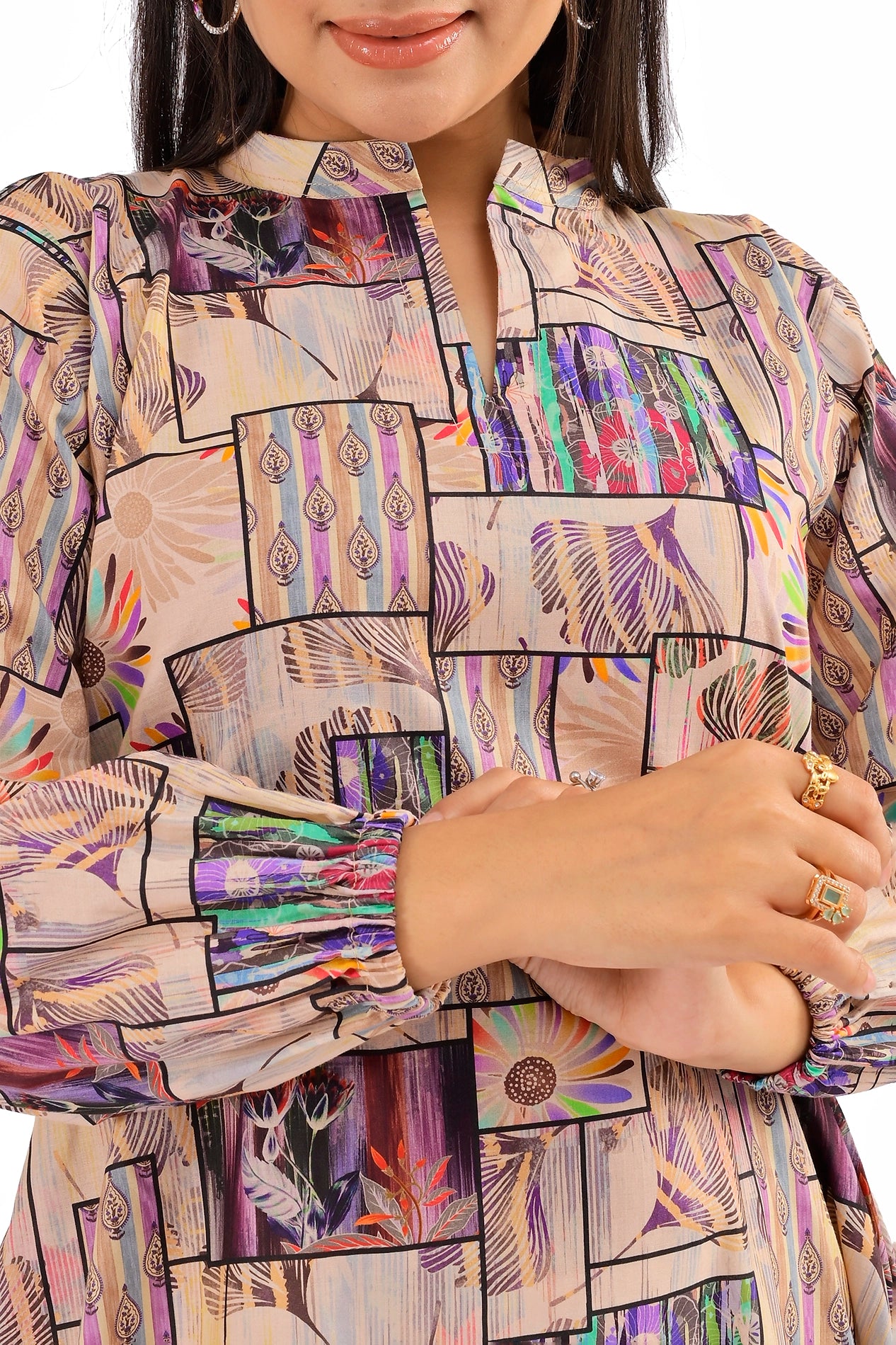 Detailed view of elasticated cuffs and colorful patchwork designs on a beige A-line dress, complemented by stylish accessories. BOLDSTEP BOLDSTEP.PK