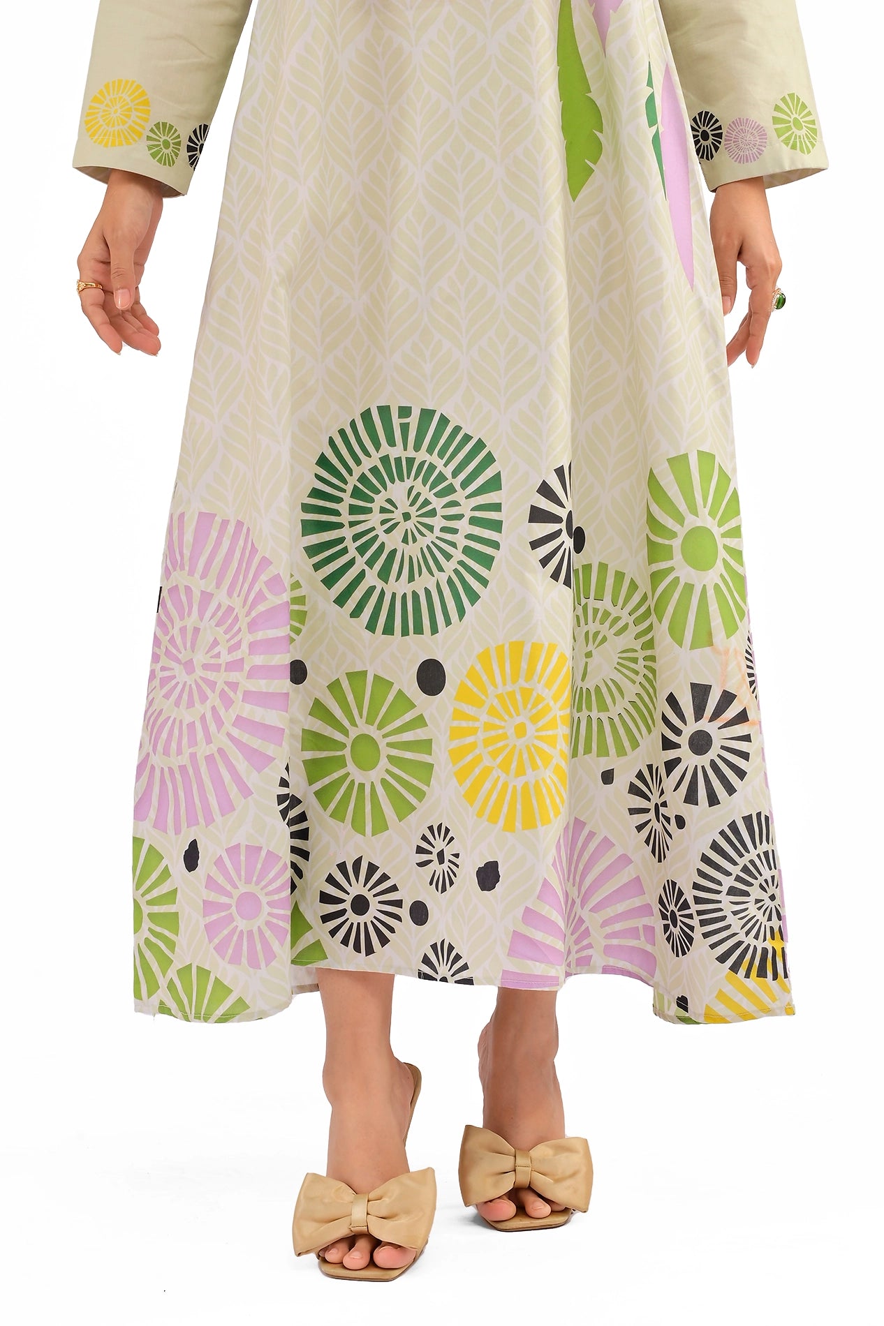 Focus on the colorful circular floral motifs at the hemline paired with beige bow heels. BOLDSTEP BOLDSTEP.PK