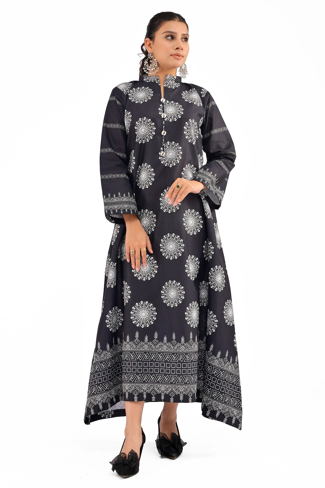 Front view of a black dress with intricate white medallion motifs and metallic button detailing on the high-collar neckline, styled with statement earrings. BOLDSTEP BOLDSTEP.PK