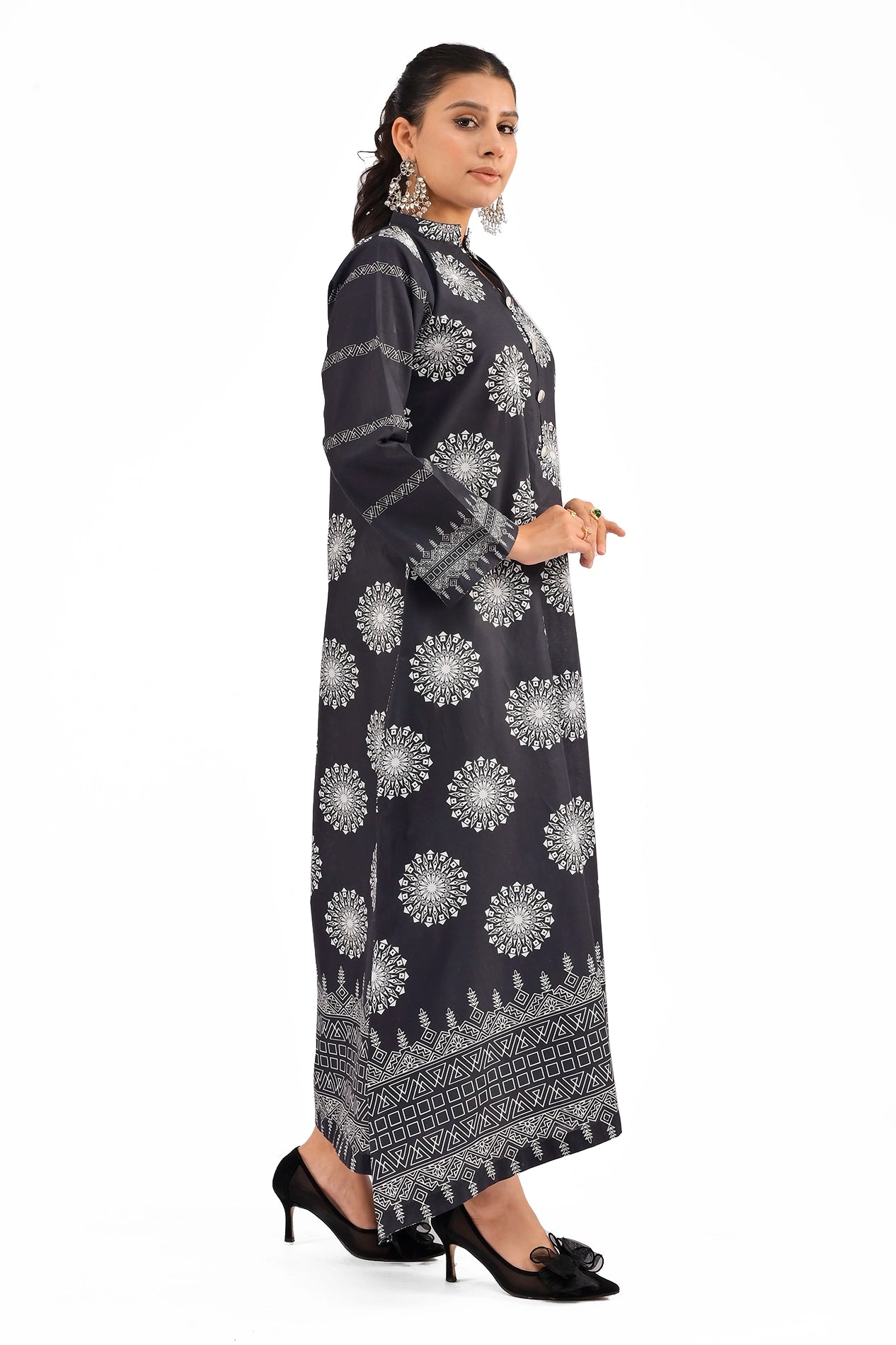Side view of a black dress featuring symmetrical white motifs, long sleeves, and geometric white patterns on the hemline. BOLDSTEP BOLDSTEP.PK