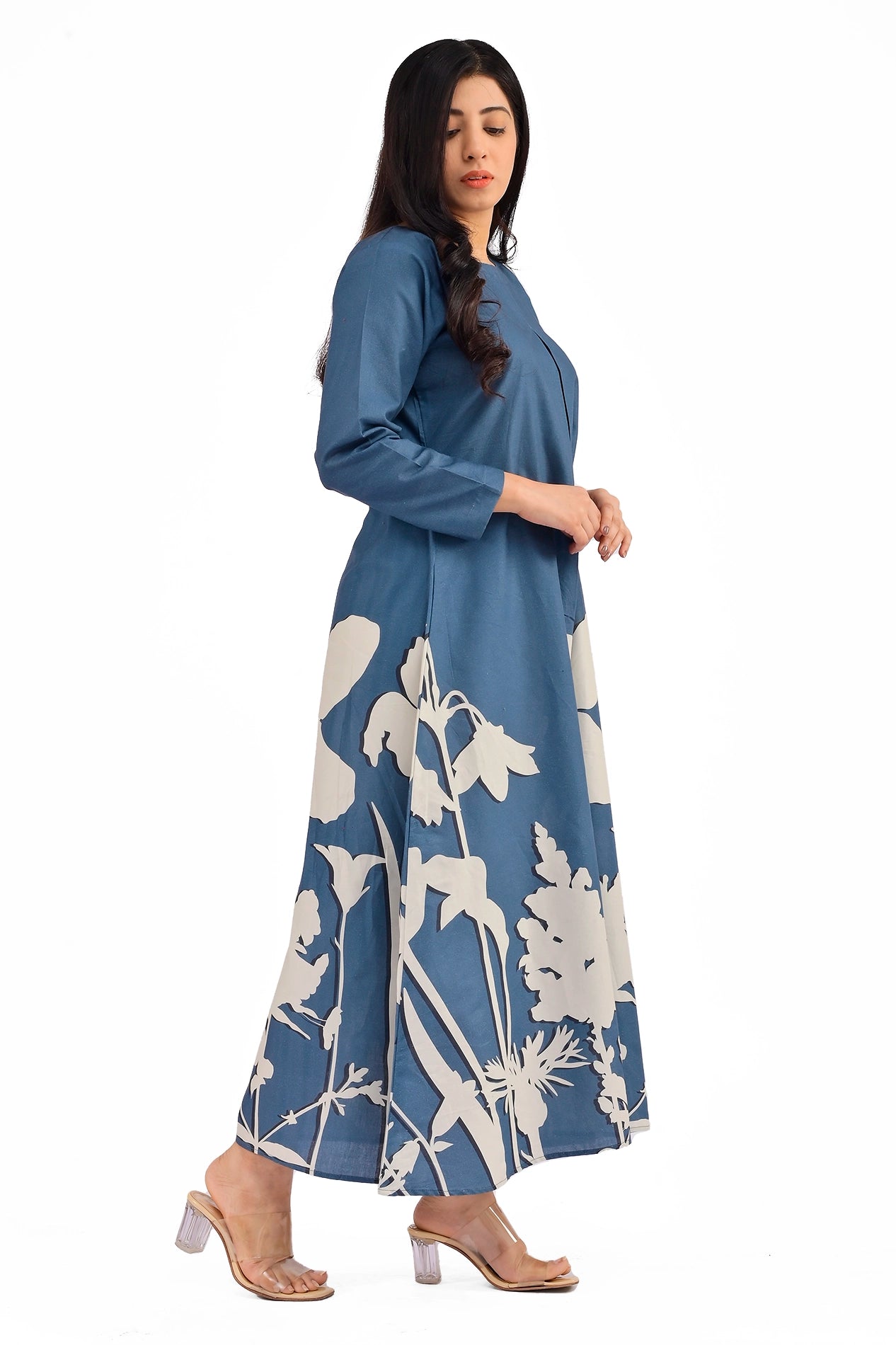Side view of a blue A-line dress with white floral patterns near the hem, showcasing a clean long-sleeve design and a relaxed fit. BOLDSTEP BOLDSTEP.PK