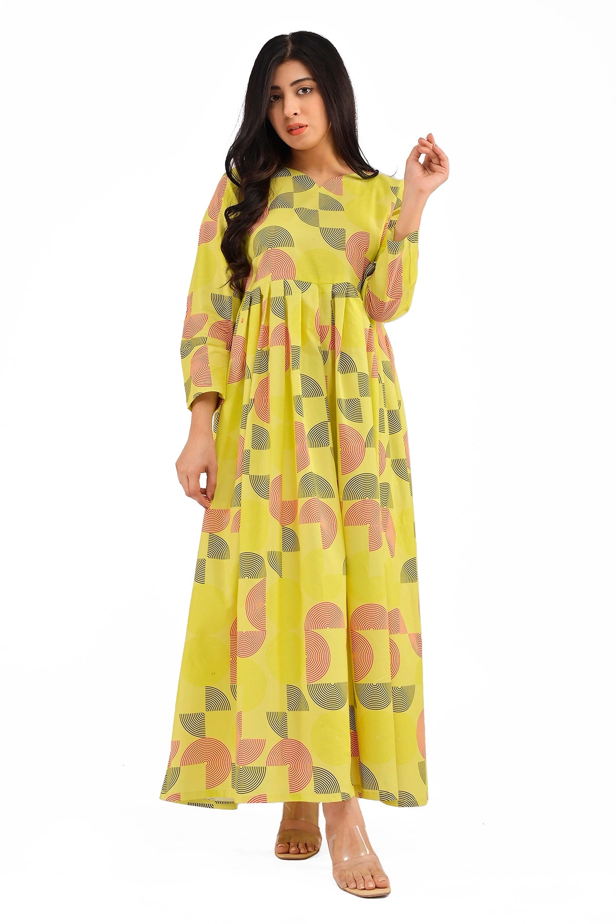 A front-facing view of a yellow A-line dress with a gathered waistline and contemporary geometric print. The model strikes a soft pose, emphasizing the dress's flowy and comfortable fabric. BOLDSTEP BOLDSTEP.PK