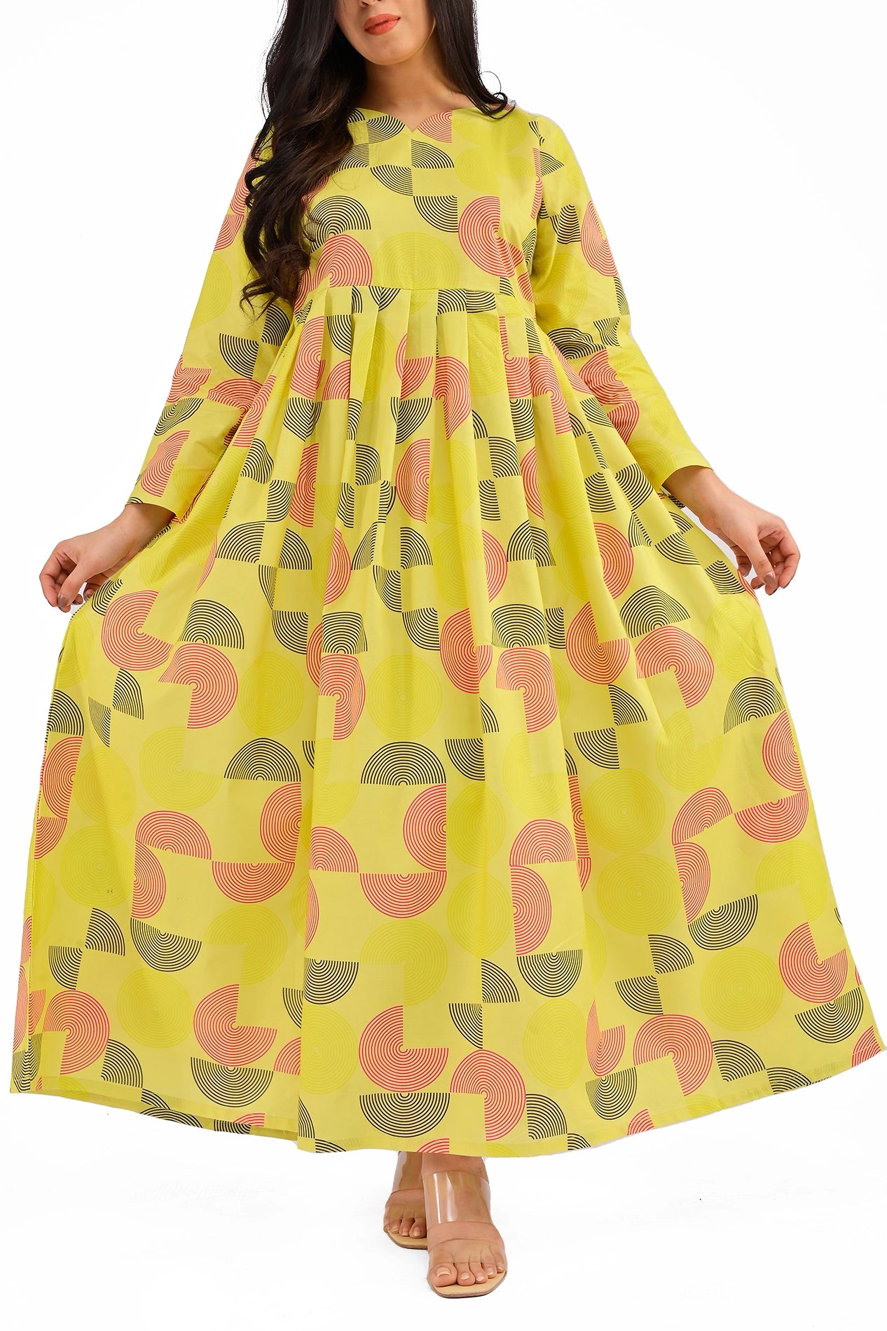 The model spreads the flowing skirt of the dress, highlighting the vibrant geometric print in coral and black on a yellow background. The gathered waistline adds volume to the silhouette. BOLDSTEP BOLDSTEP.PK