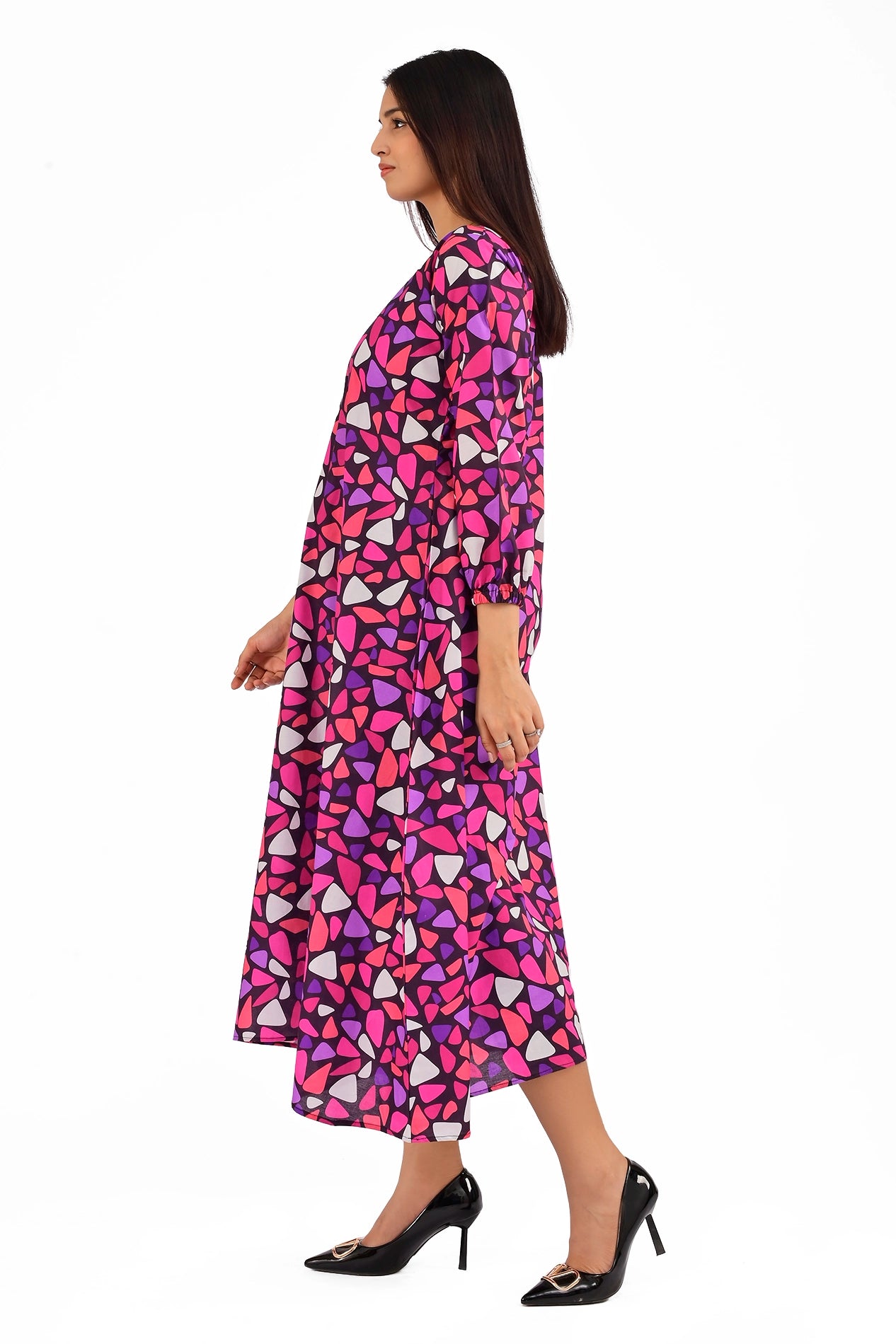 Side view of a woman in a colorful mosaic-inspired dress with a flowing A-line silhouette, showcasing the vibrant geometric print and relaxed fit. BOLDSTEP BOLDSTEP.PK