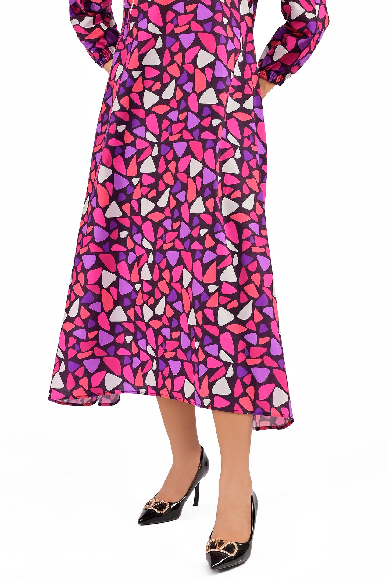 Front view of a woman showcasing the bold mosaic-printed dress, paired with elegant black pointed heels for a chic look. BOLDSTEP BOLDSTEP.PK