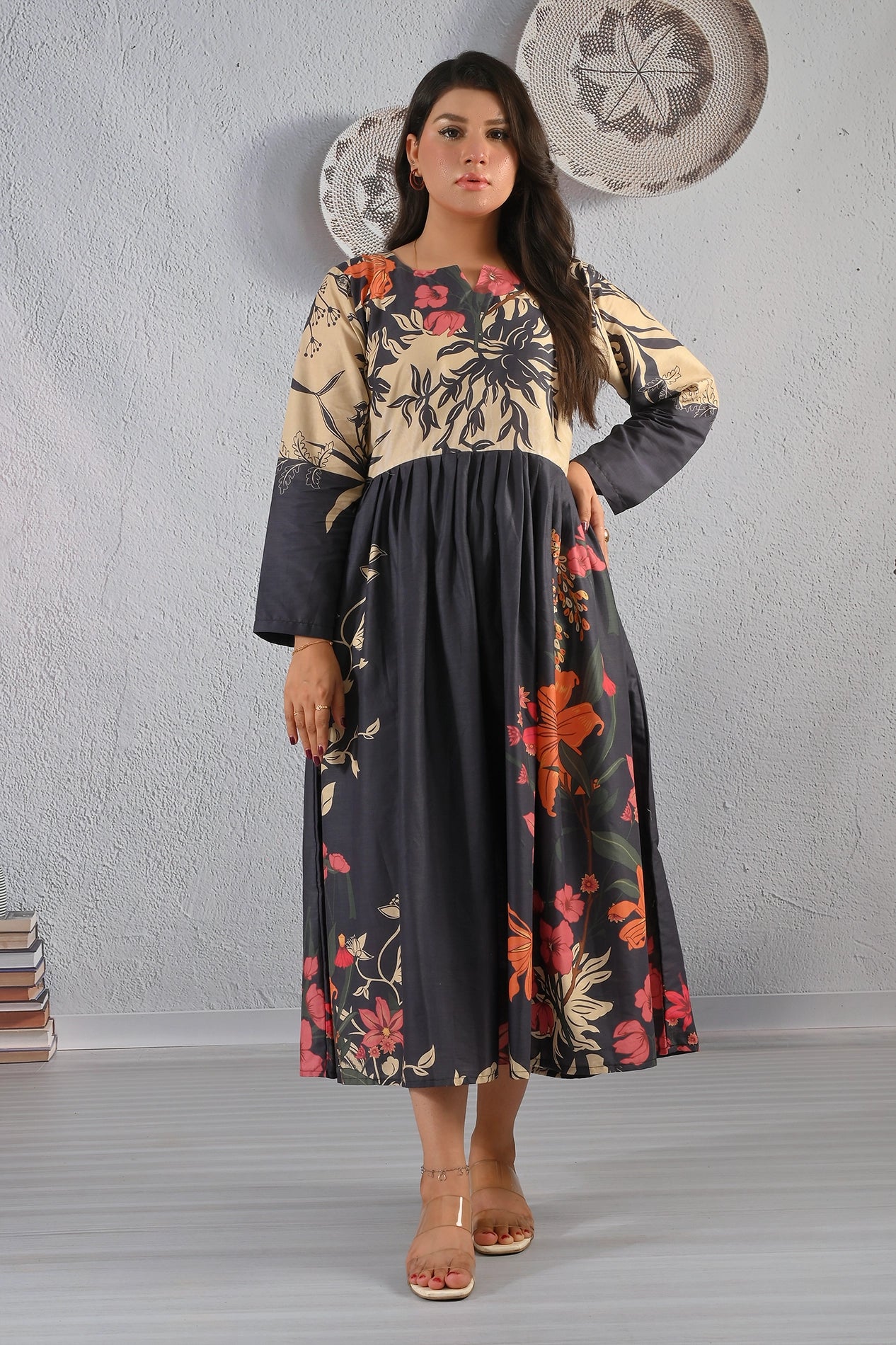 Model wearing BOLDSTEP floral printed cotton maxi dress in beige and black with red-orange flowers – BOLD STEP exclusive at BOLDSTEP.PK | BOLDSTEP STORE