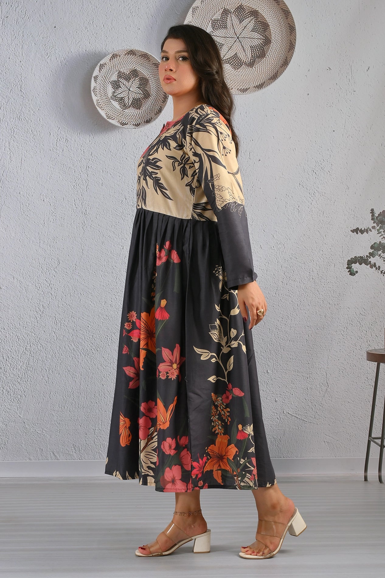 Side angle of BOLDSTEP floral maxi dress in beige and black cotton fabric, featuring bold orange and red floral prints – BOLD STEP design at BOLDSTEP STORE