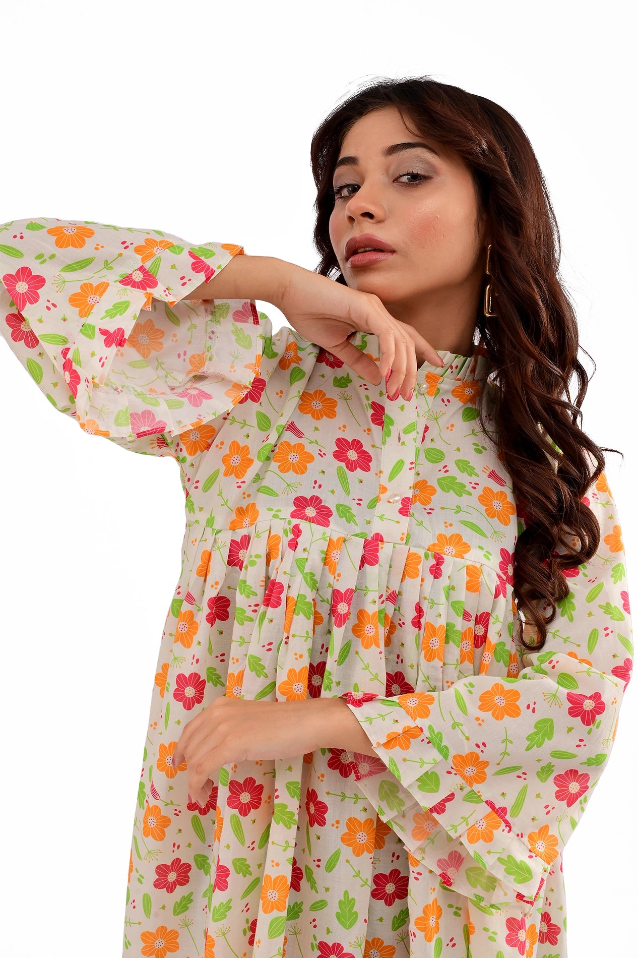 A close-up of the model highlighting the tunic’s detailed floral print, ruffled neckline, and soft pleats