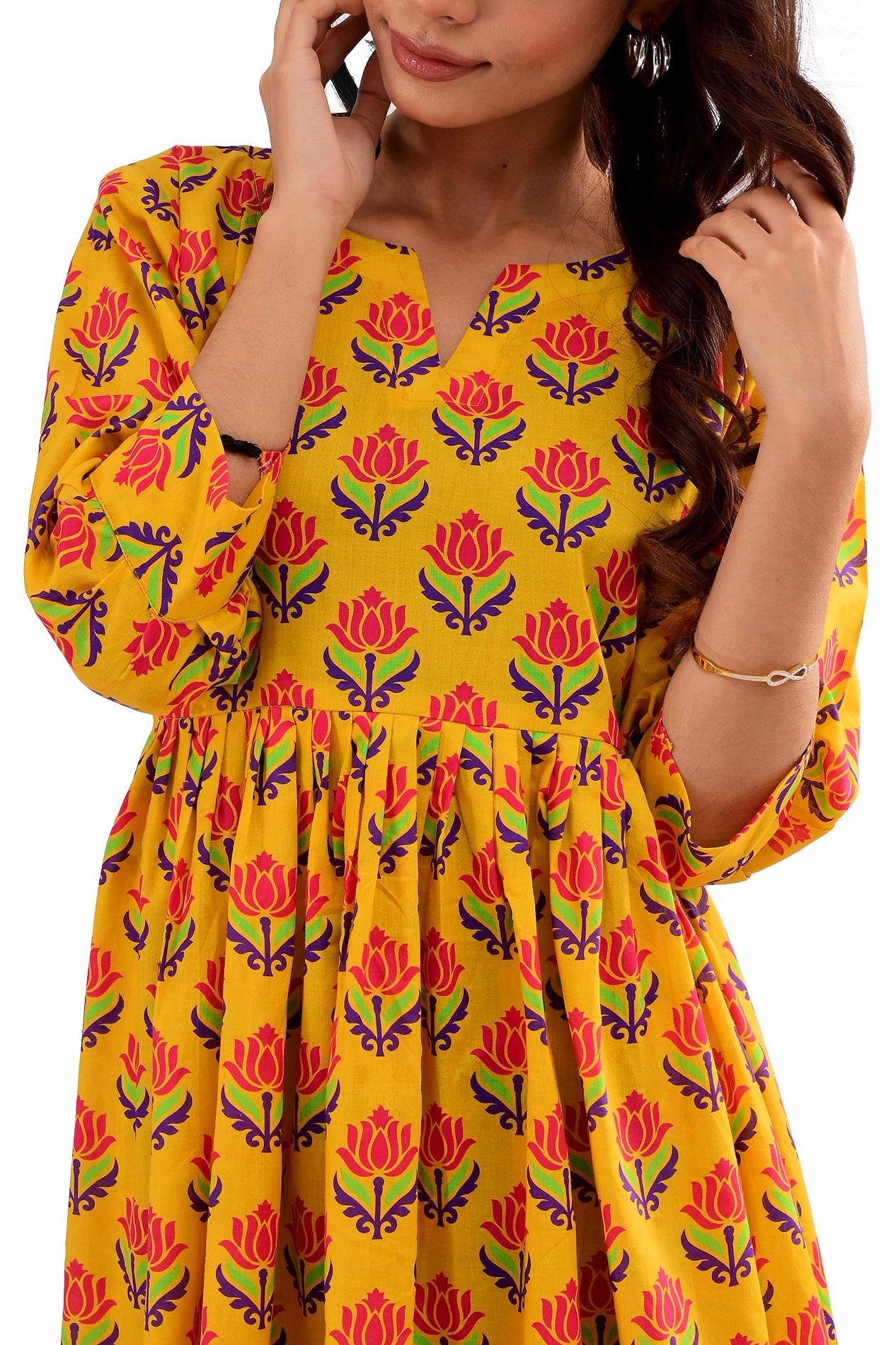 Detailed view of the tunic’s floral pattern and soft fabric, showing the three-quarter sleeves and relaxed fit