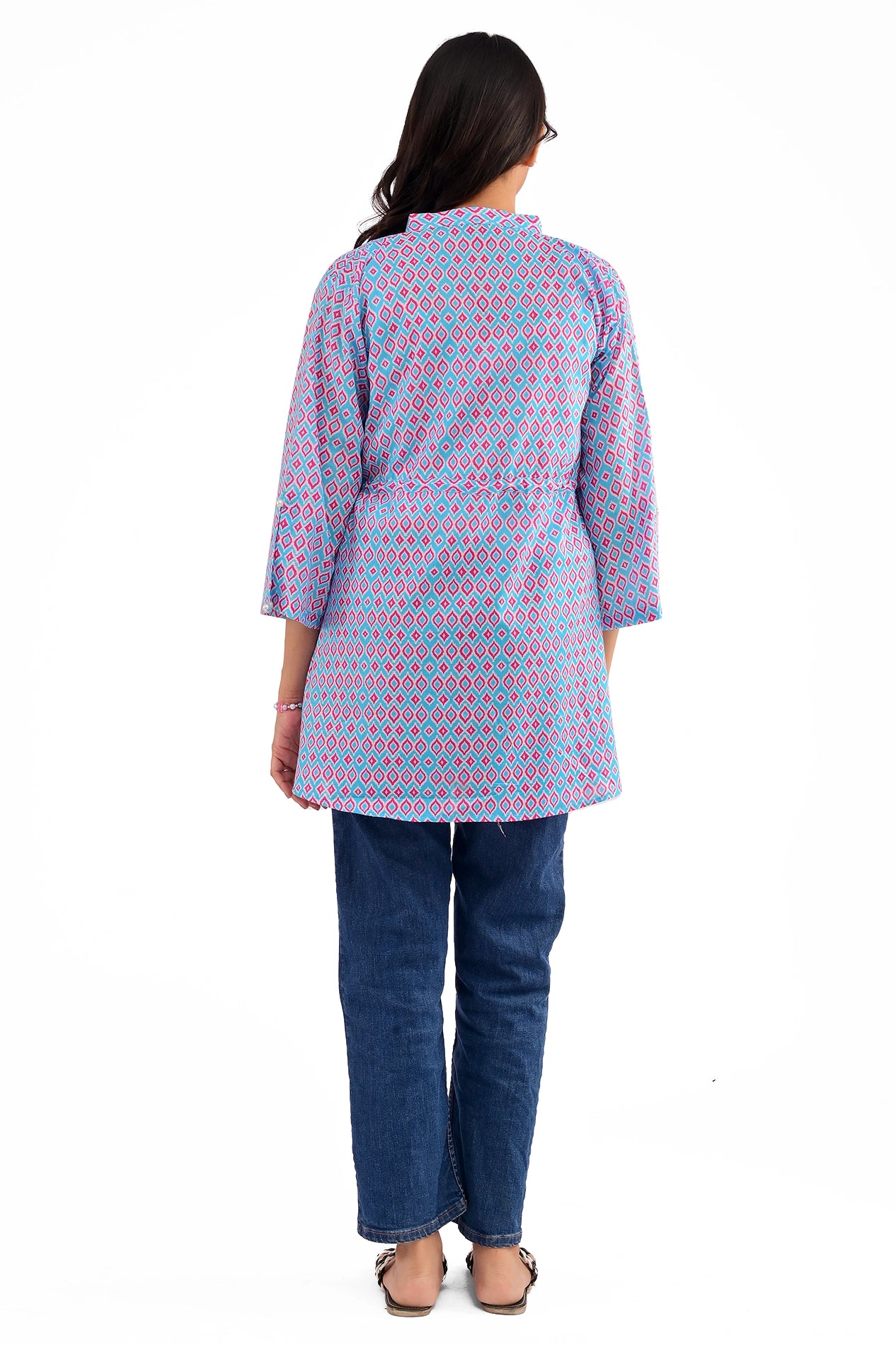 Back view of the blue and pink geometric print tunic, showing its fit and flared design