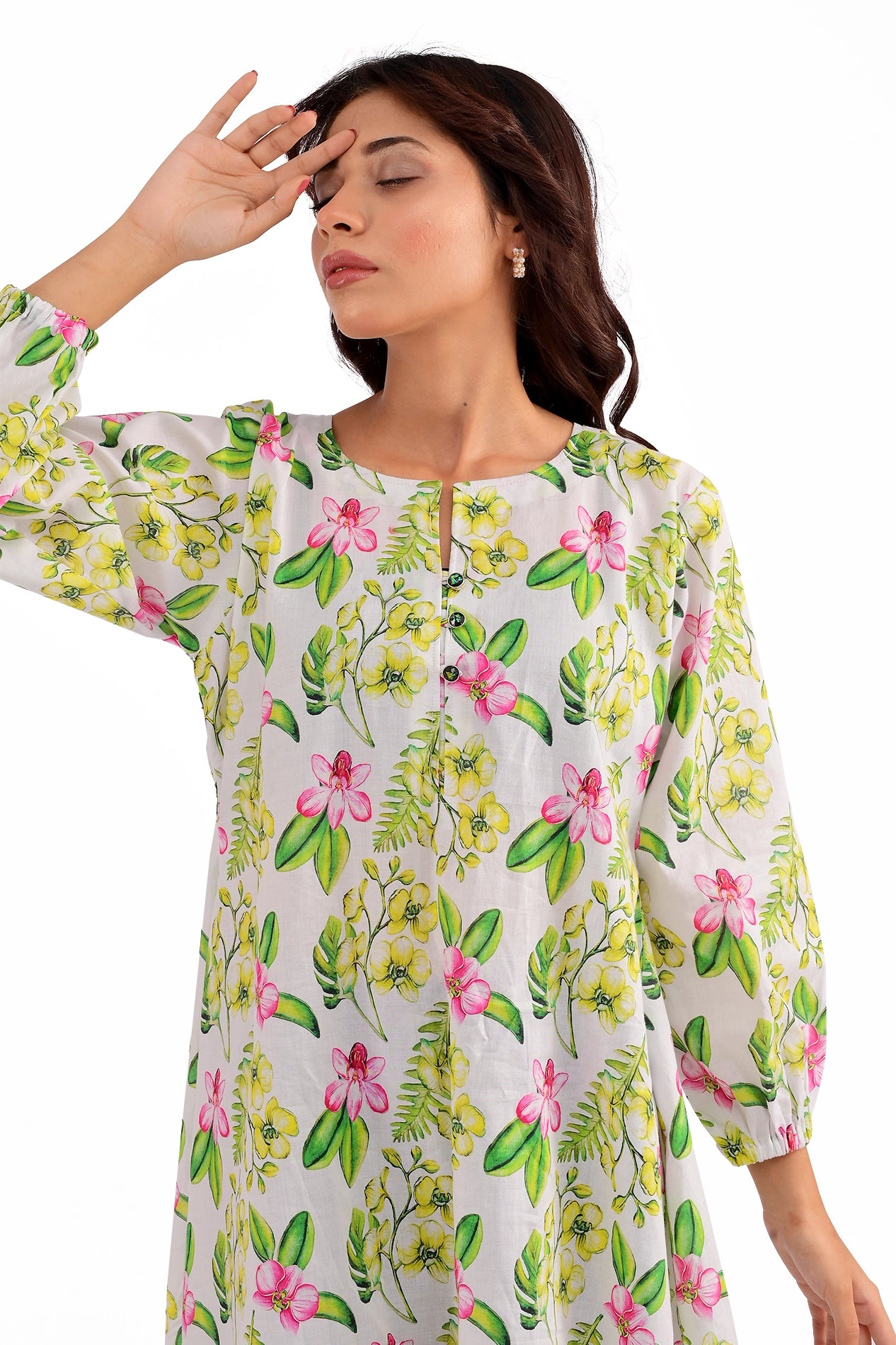 Close-up of the model wearing the floral tunic, emphasizing the neckline and delicate button details