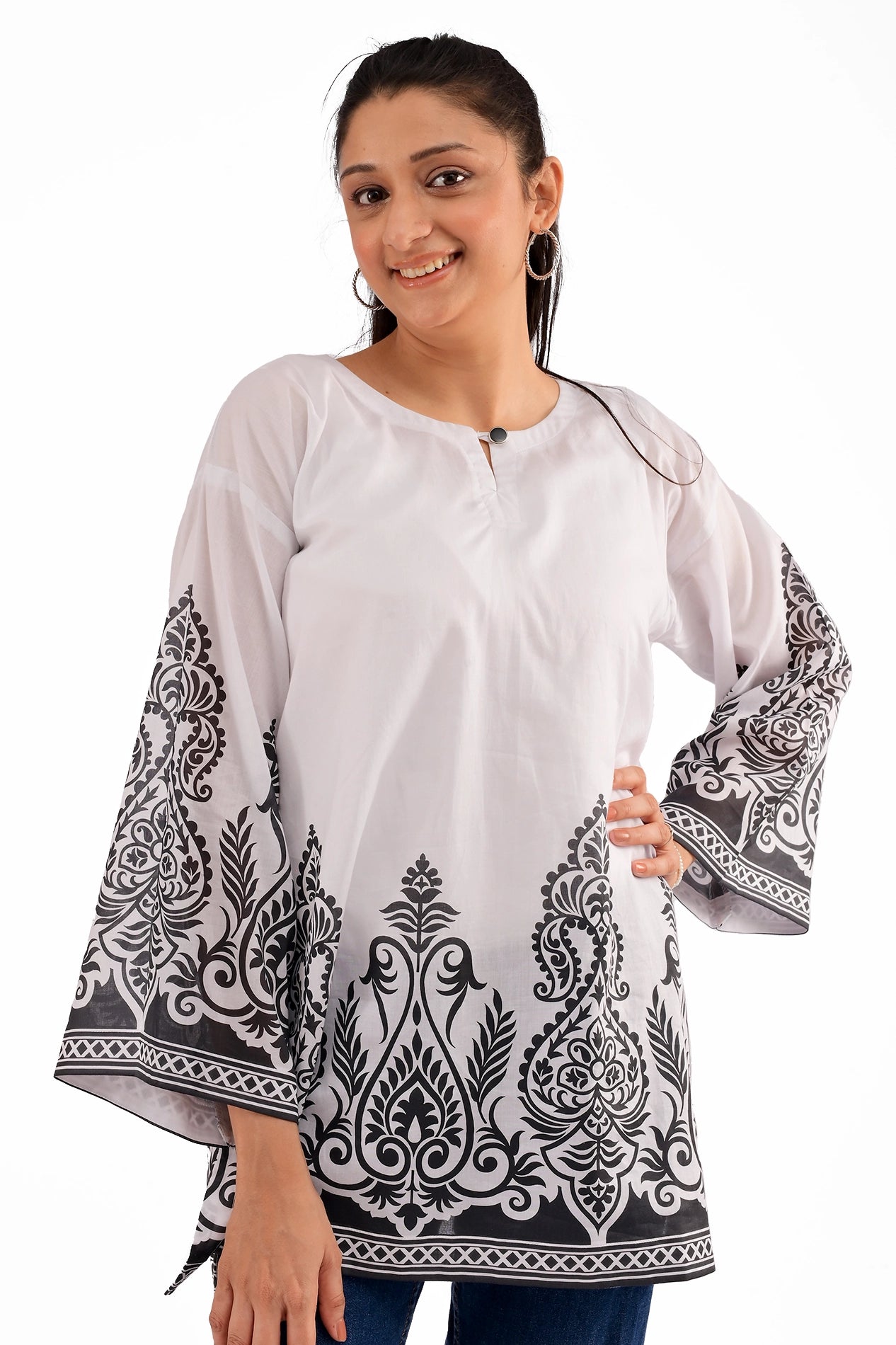 A closer look at the kurti’s neckline, featuring a minimal round neck with a small keyhole and a black button detail, emphasizing the intricate black motif prints on the sleeves and hem