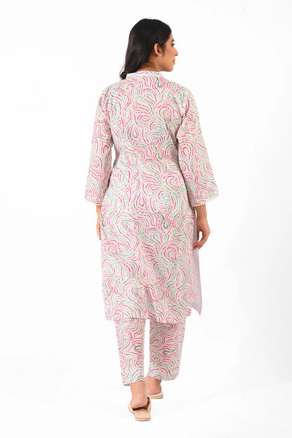 A rear view of a woman wearing the pastel-patterned kurta set. The straight cut and traditional design are highlighted as she gracefully poses with relaxed posture BOLDSTEP BOLDSTEP.PK