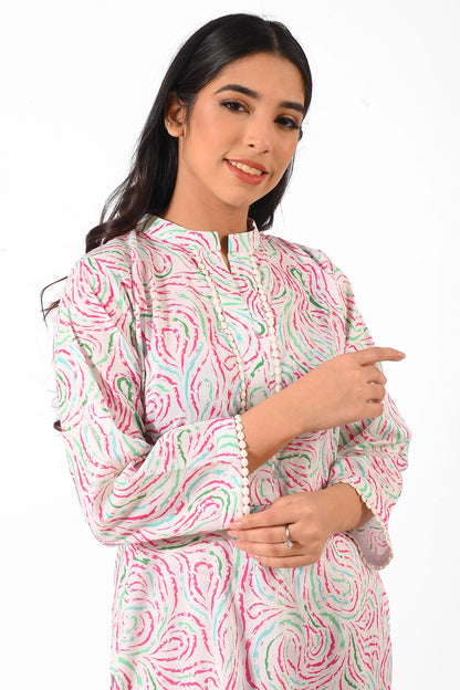 A close-up of a smiling woman wearing the pastel swirl-patterned kurta set, emphasizing the delicate detailing on the collar and the minimal, elegant stitching. BOLDSTEP BOLDSTEP.PK