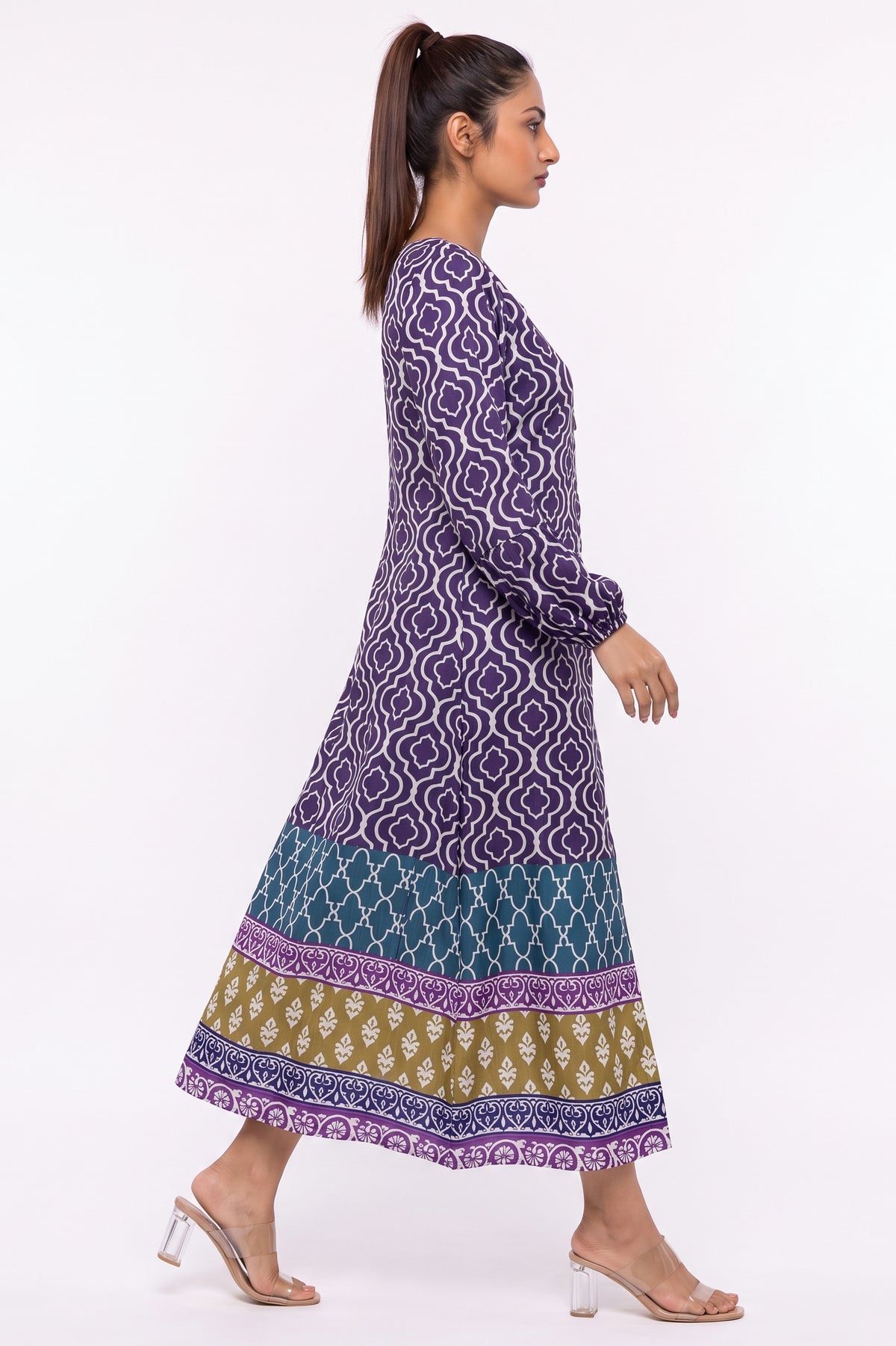 Side profile view of BOLDSTEP purple geometric trellis printed winter maxi dress in motion.