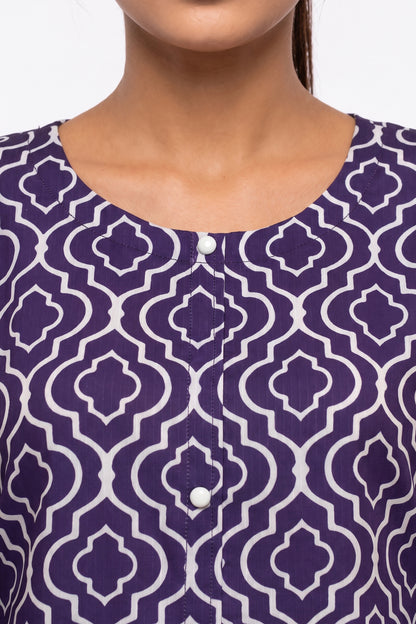 Close-up view of round neckline featuring white accent buttons on purple trellis print fabric.