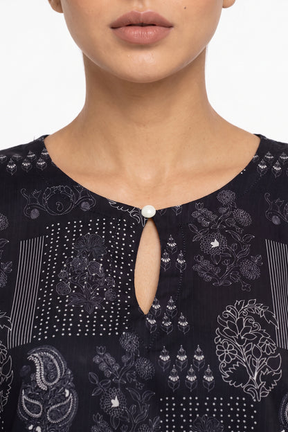 Close-up of keyhole button neckline on navy white block-printed Swiss Bana Dora fabric.