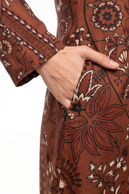 Close-up of functional side seam pocket on BOLDSTEP rust brown batik printed Swiss Bana Dora maxi dress.