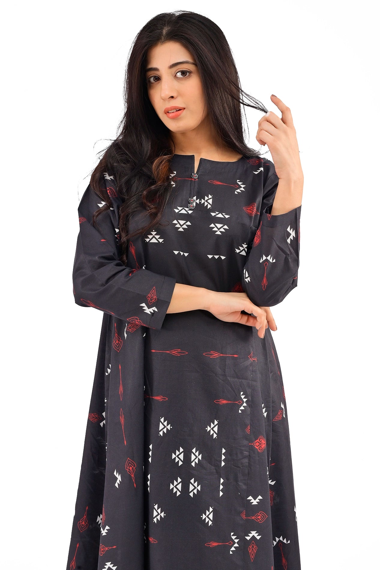 Close-up of a model showcasing the neckline and detailed red and white geometric patterns on a black dress, emphasizing the fine craftsmanship. BOLDSTEP BOLDSTEP.PK