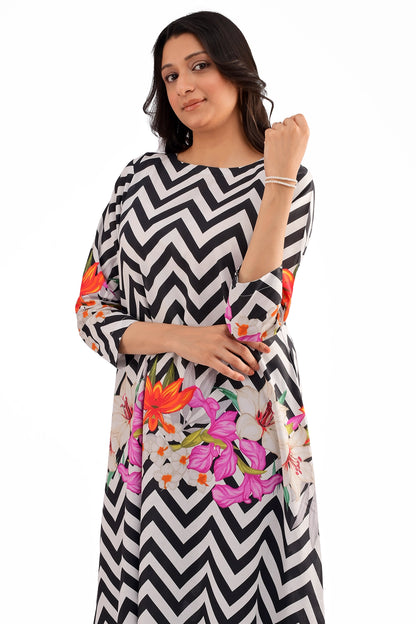 A close-up of the dress's upper section, highlighting the bold chevron print and vibrant floral accents on the sleeves, paired with minimal jewelry.