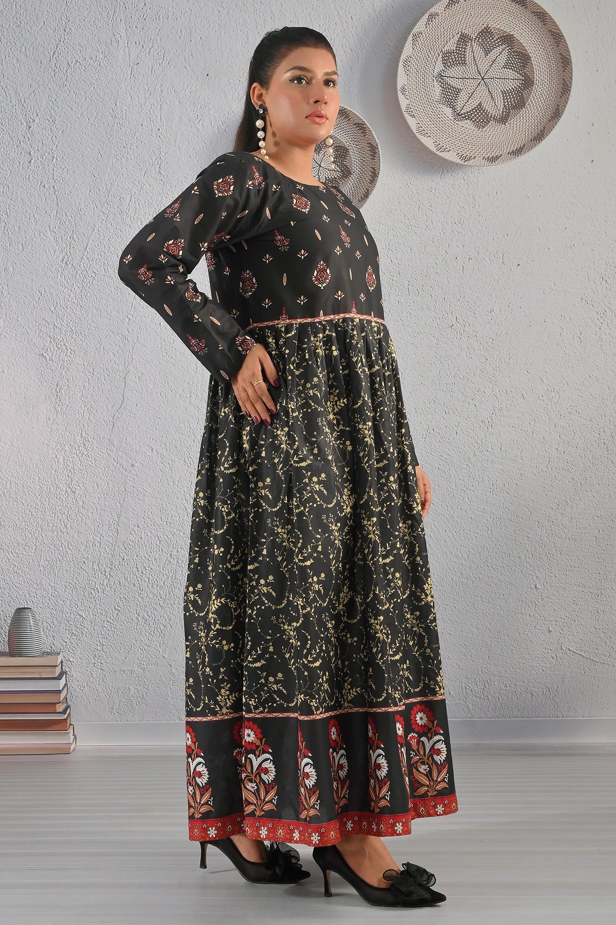 Side view of BOLDSTEP black and gold cotton maxi dress with red ethnic motifs and flared hemline – stylish and graceful outfit by BOLD STEP | BOLDSTEP.PK | BOLDSTEP STORE.