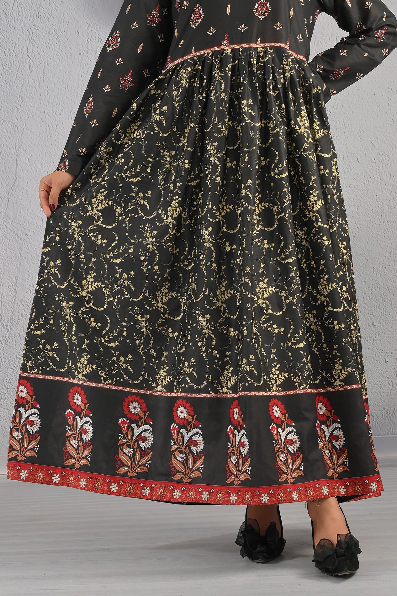 Detailed view of BOLDSTEP black and gold printed maxi dress featuring ornate floral patterns and red embroidered-style border – luxury cotton outfit from BOLD STEP | BOLDSTEP.PK | BOLDSTEP STORE.
