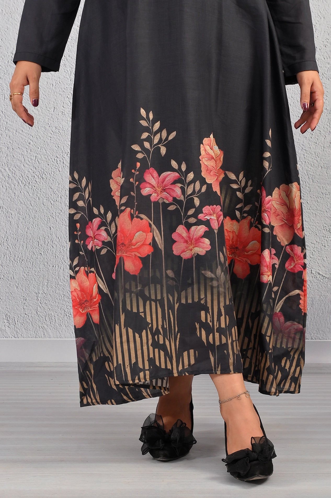 Hemline close-up of BOLDSTEP black maxi dress showcasing red floral border and golden grass print – premium cotton finish | BOLD STEP | BOLDSTEP.PK | BOLDSTEP STORE.
