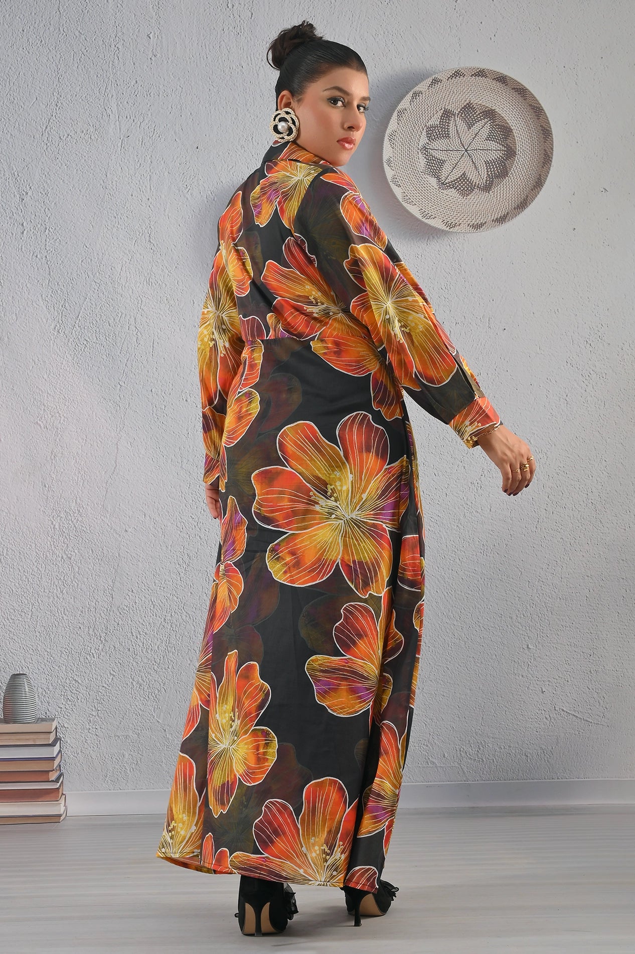 Back view of BOLDSTEP black floral maxi dress featuring large orange and mustard flower prints, full-length silhouette, and elegant fit | BOLD STEP | BOLDSTEP.PK | BOLDSTEP STORE.