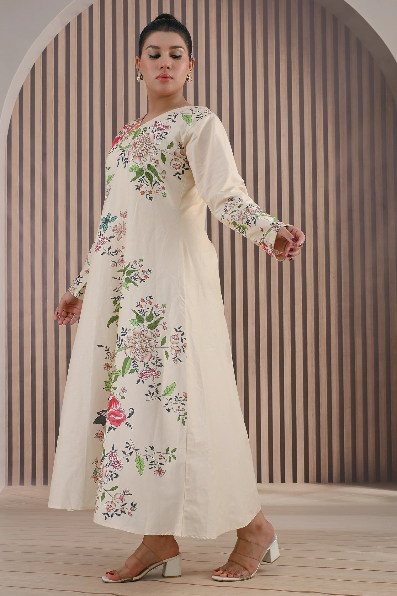 Side angle view of BOLDSTEP cream long floral printed maxi dress featuring red, pink, and green botanical patterns – graceful flowy design | BOLD STEP | BOLDSTEP.PK | BOLDSTEP STORE.