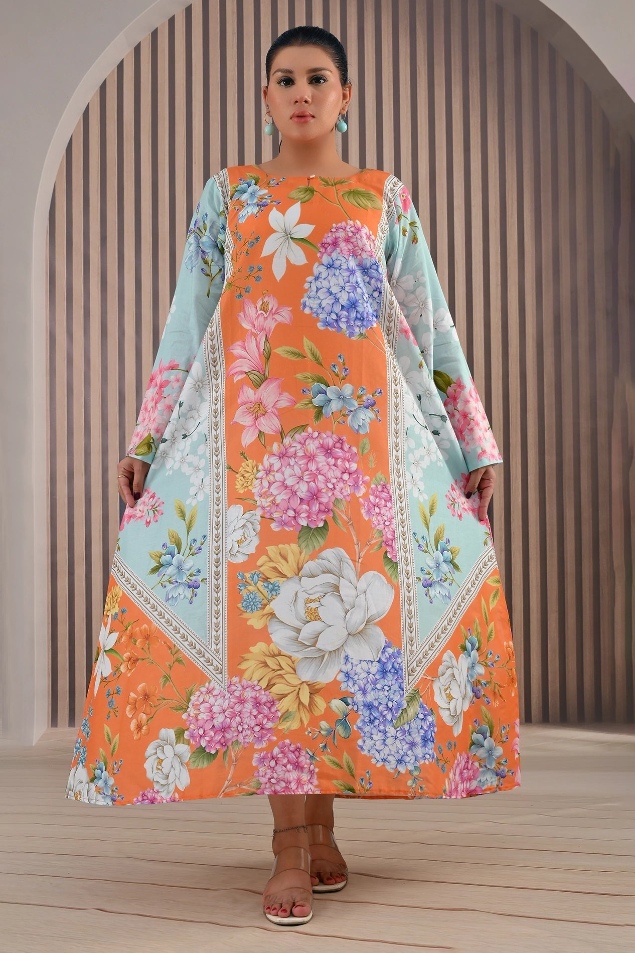Front full view of BOLDSTEP vibrant floral printed maxi dress featuring orange base with blue and pink flowers, long sleeves, and elegant A-line silhouette | BOLD STEP | BOLDSTEP.PK | BOLDSTEP STORE.