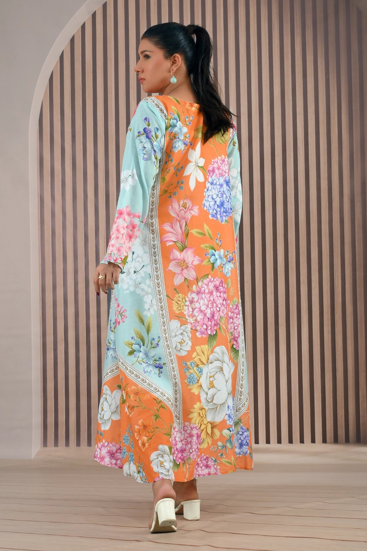 Back angled view of BOLDSTEP floral maxi dress highlighting bold color contrast of orange and mint with blooming floral prints | BOLD STEP | BOLDSTEP.PK | BOLDSTEP STORE.