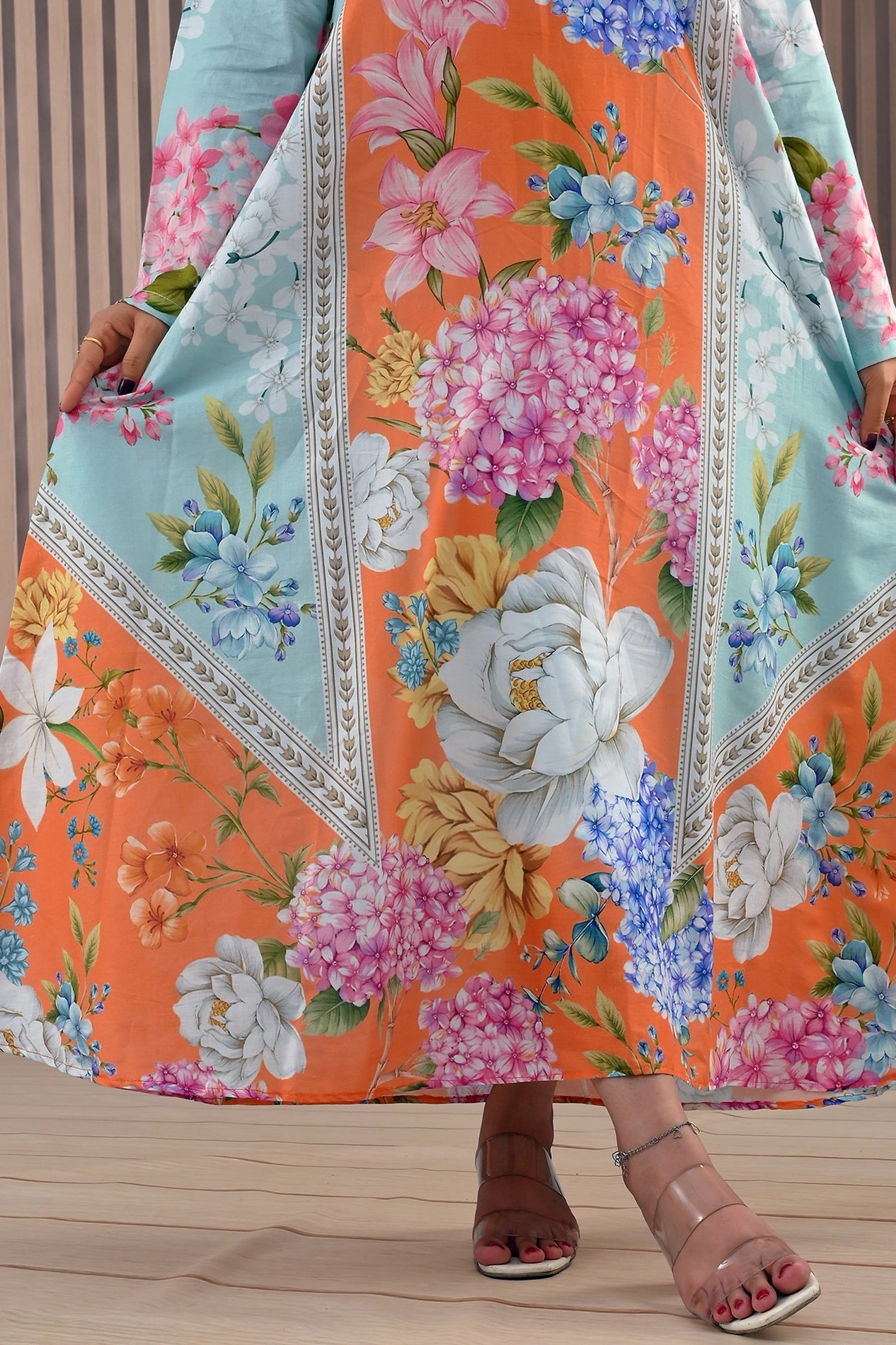 Close-up of the hemline of BOLDSTEP orange floral maxi dress showing intricate floral prints and premium stitched detailing | BOLD STEP | BOLDSTEP.PK | BOLDSTEP STORE.