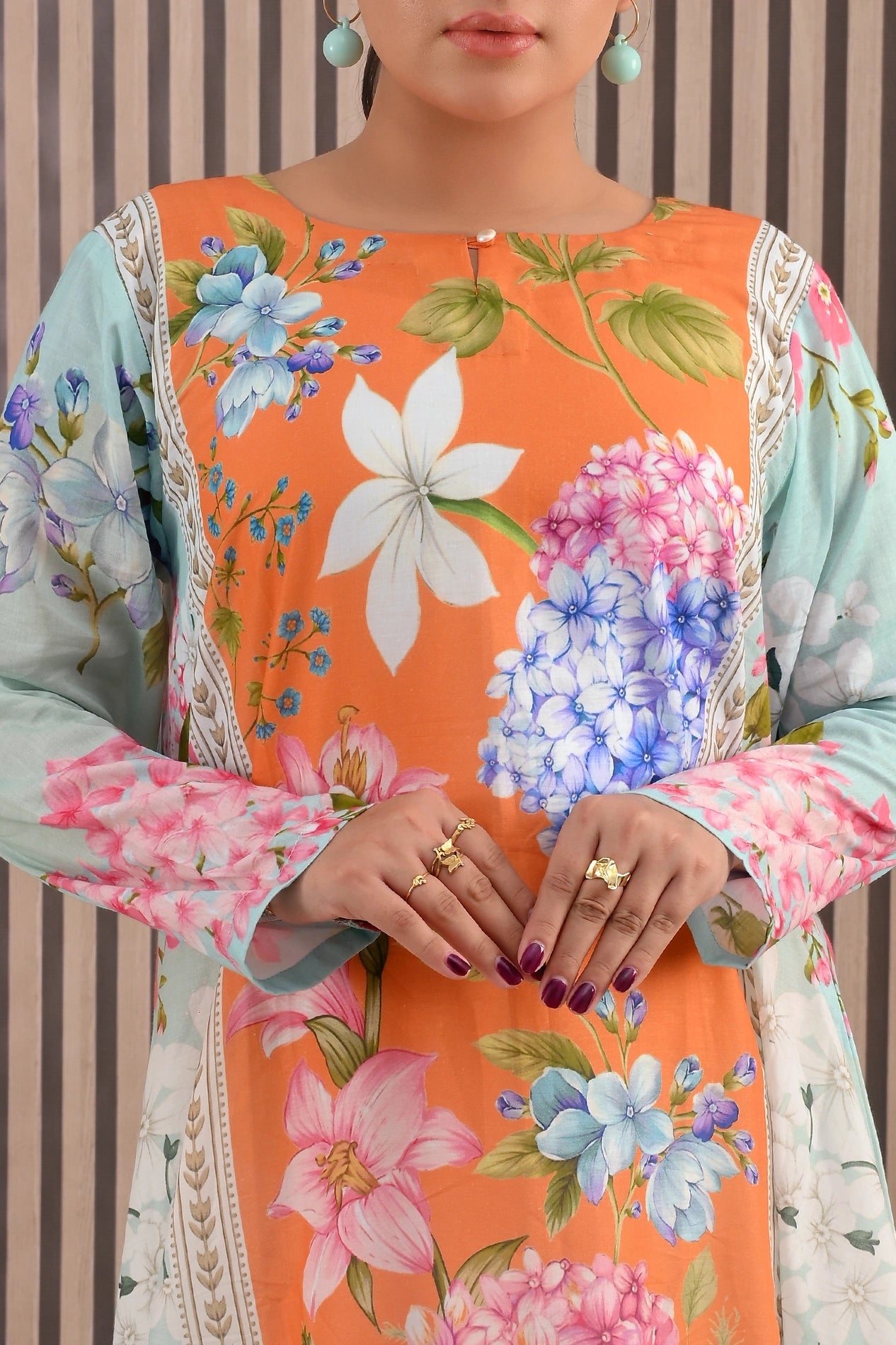 Close-up of BOLDSTEP floral maxi dress bodice with orange and turquoise contrast, detailed floral artwork, and full sleeves | BOLD STEP | BOLDSTEP.PK | BOLDSTEP STORE.
