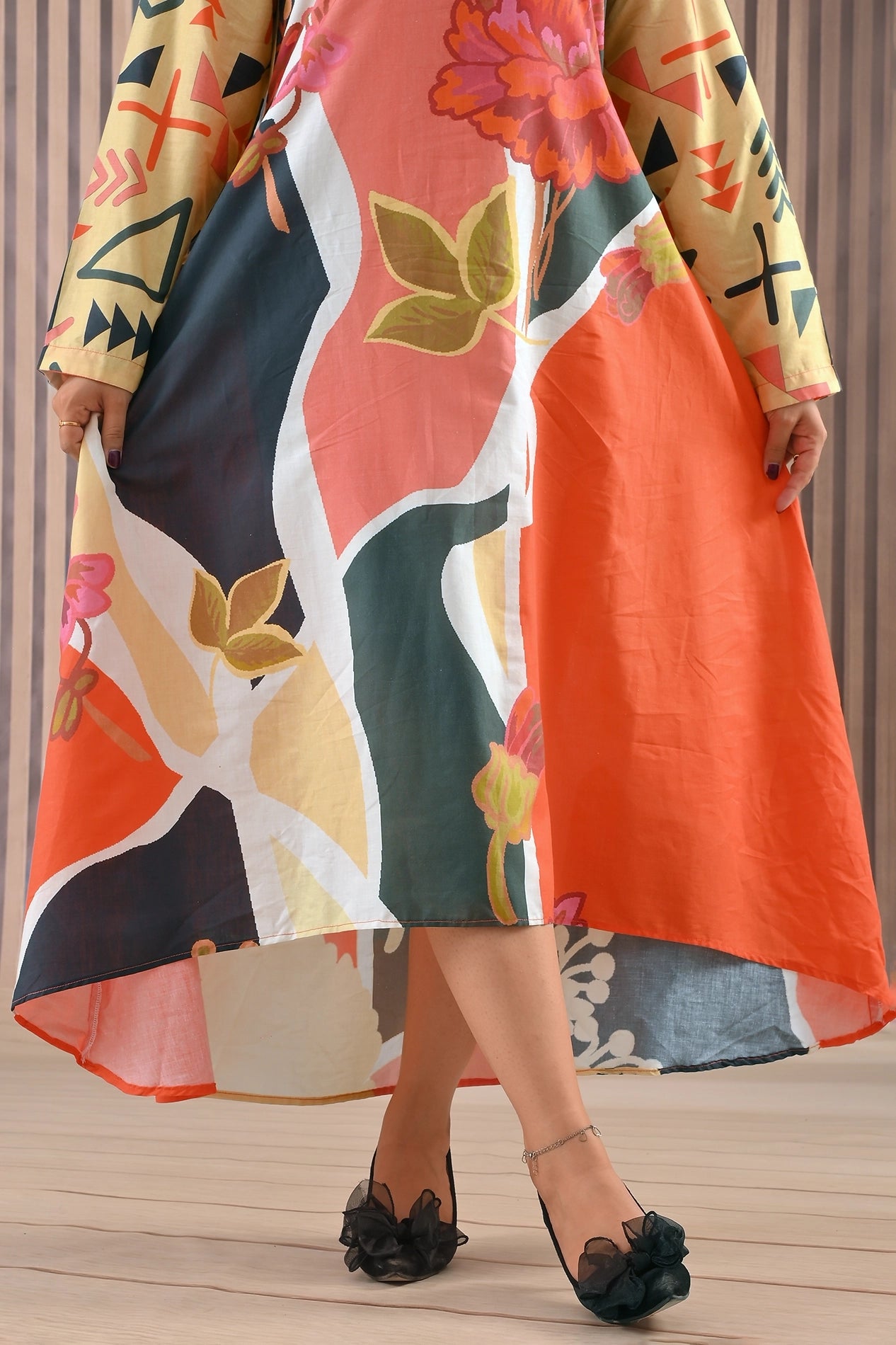 Close-up of BOLDSTEP floral abstract maxi dress showing detailed print composition in coral, yellow, and black with smooth high-low hem finish | BOLD STEP | BOLDSTEP.PK | BOLDSTEP STORE.