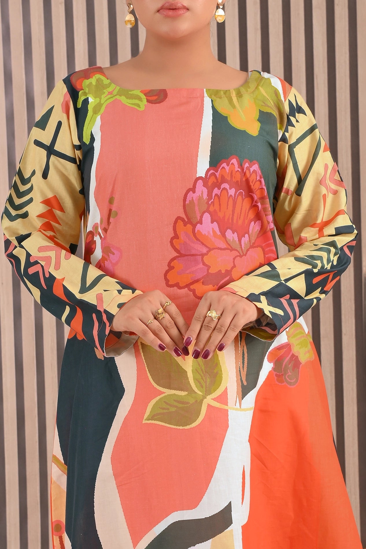 Close-up of BOLDSTEP floral printed maxi dress displaying artistic color blocks and floral motifs with mustard and coral shades on premium cotton fabric | BOLD STEP | BOLDSTEP.PK | BOLDSTEP STORE.